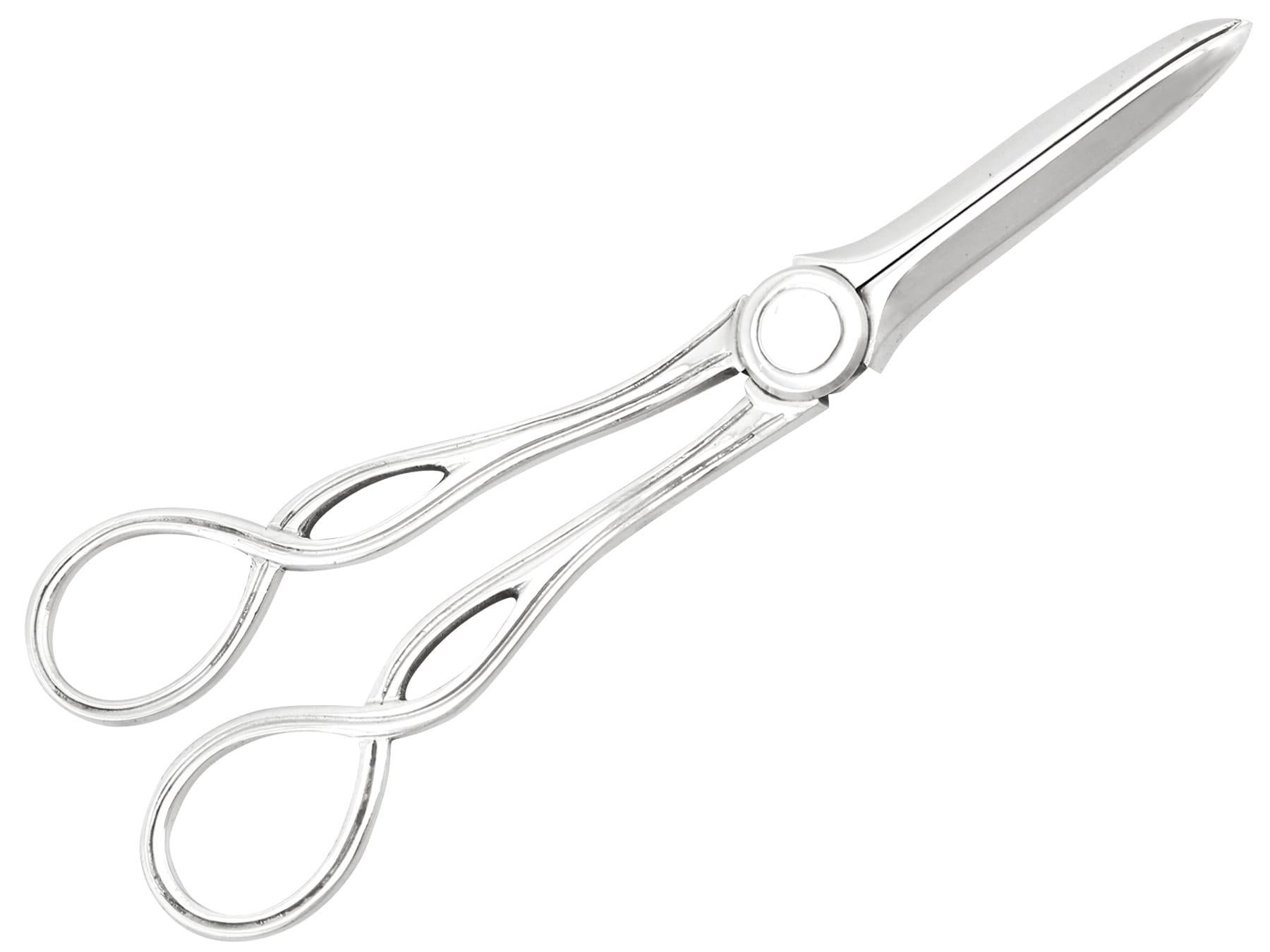 An exceptional, fine and impressive pair of antique Victorian English sterling silver grape shears, boxed, an addition to our silver flatware collection.

These exceptional antique Victorian sterling silver grape shears have a hinged scissor