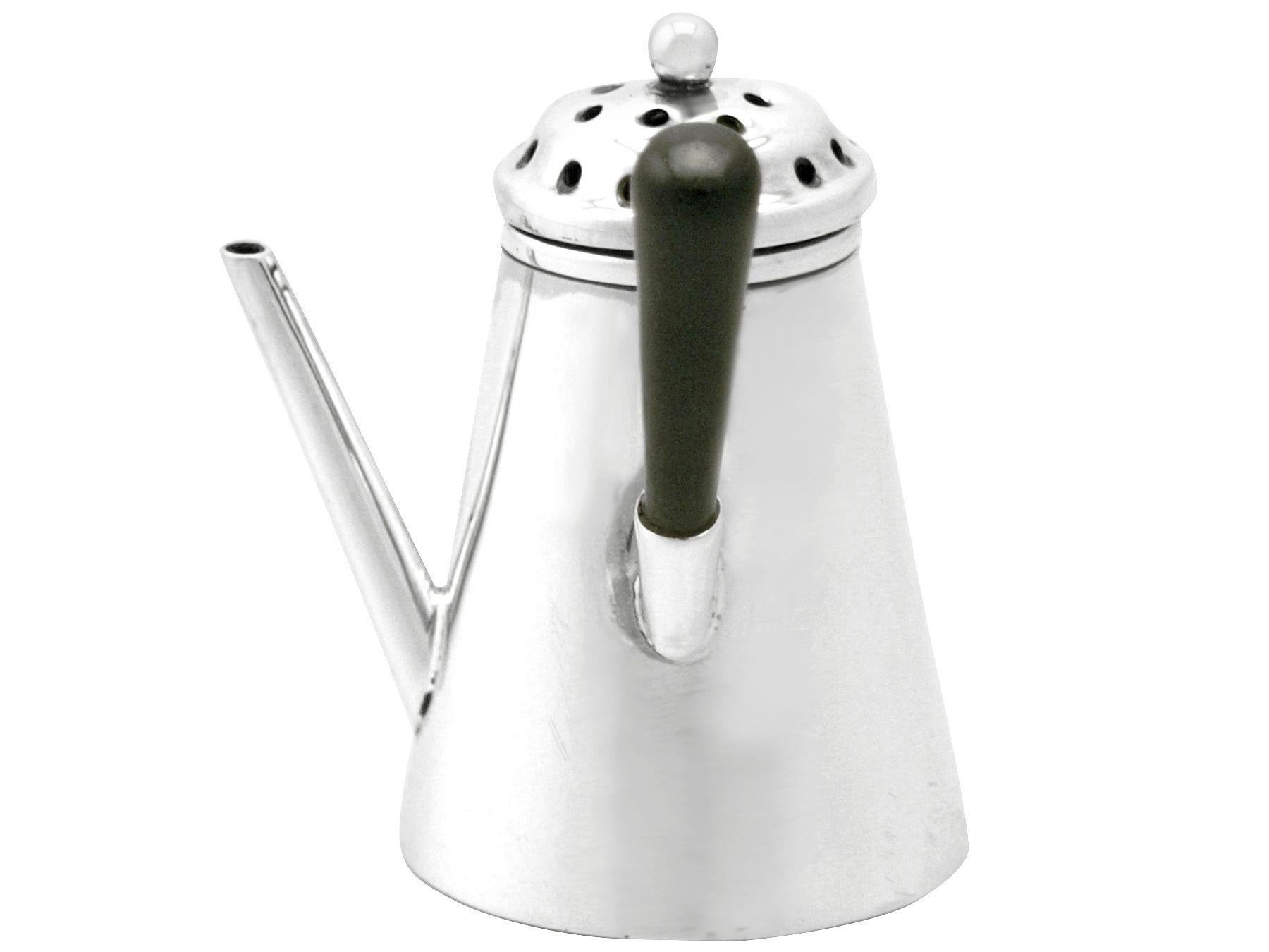 A fine antique Victorian English sterling silver novelty pepper Shaker in the form of a George I style chocolate pot; an addition to our silver cruet and condiments collection.

This fine antique Victorian silver pepper pot has been realistically