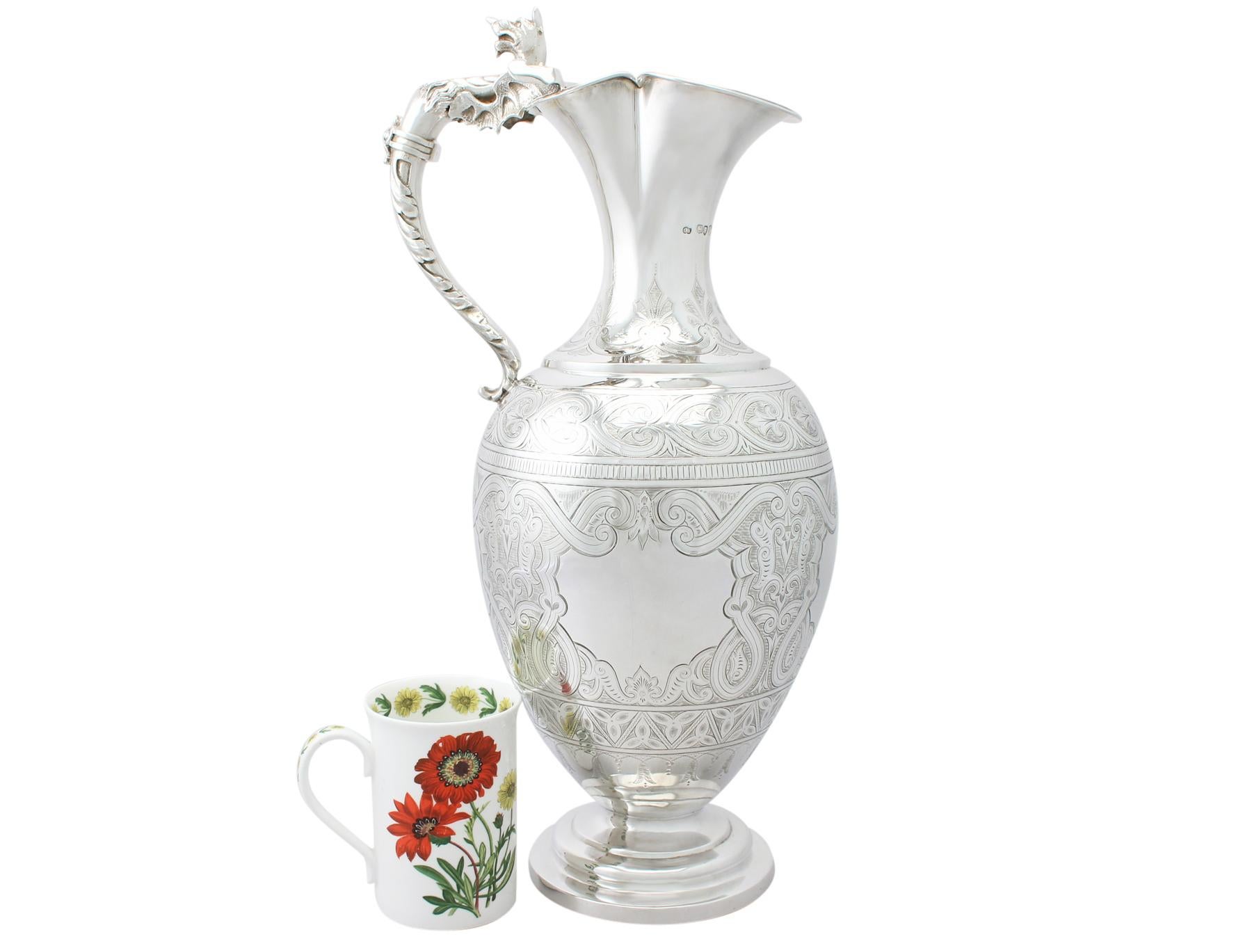 A magnificent, fine and impressive, large antique Victorian English sterling silver wine ewer; part of our wine and drinks related silverware collection.

This magnificent antique Victorian English sterling silver wine ewer has an ovoid shaped