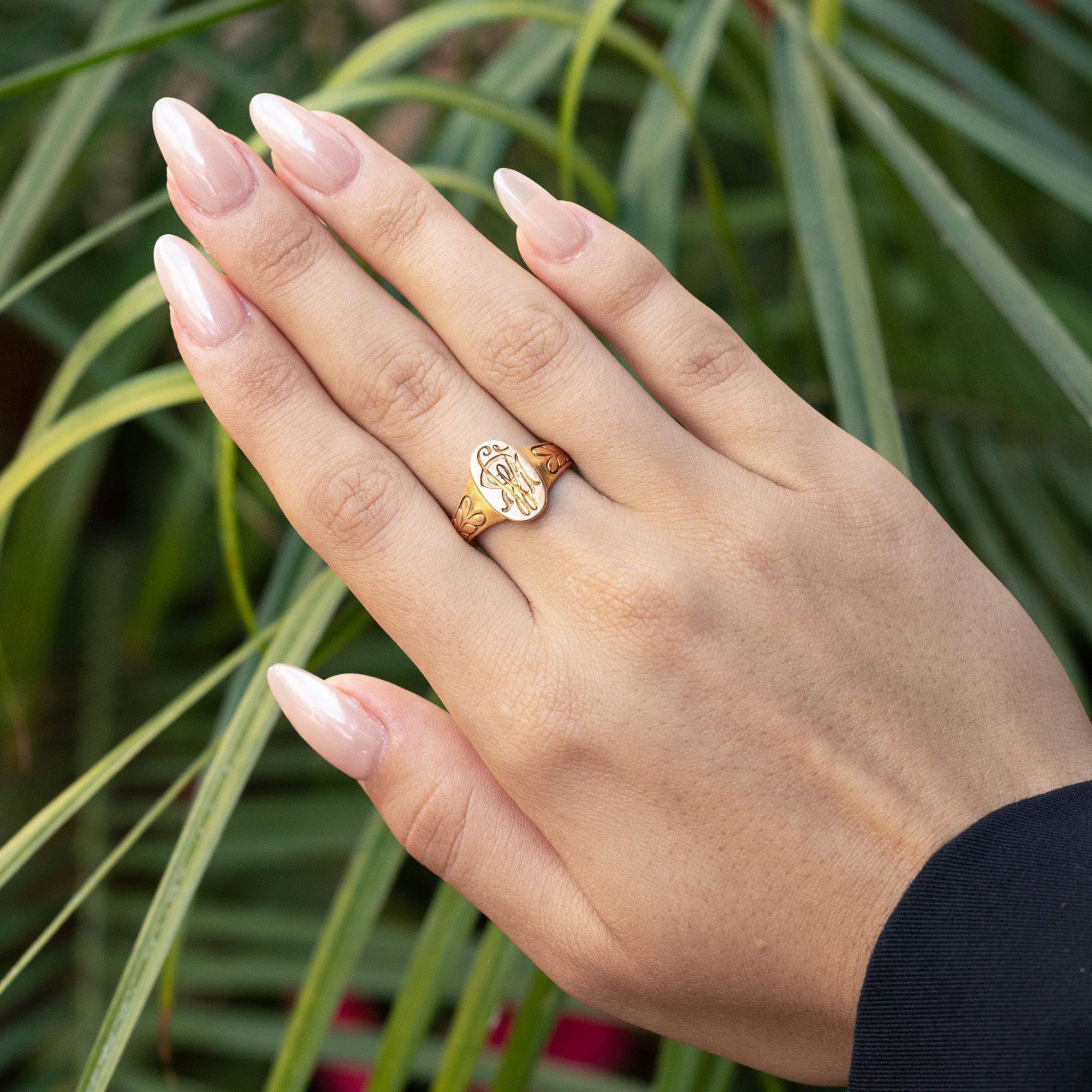 With a lasting legacy, this 125 year old Victorian signet ring is imbued with a royal monogram and adorned with a hand-engraved laurel leaf band. This heirloom was intentionally left unpolished to enjoy the original patina of the rich 14 karat