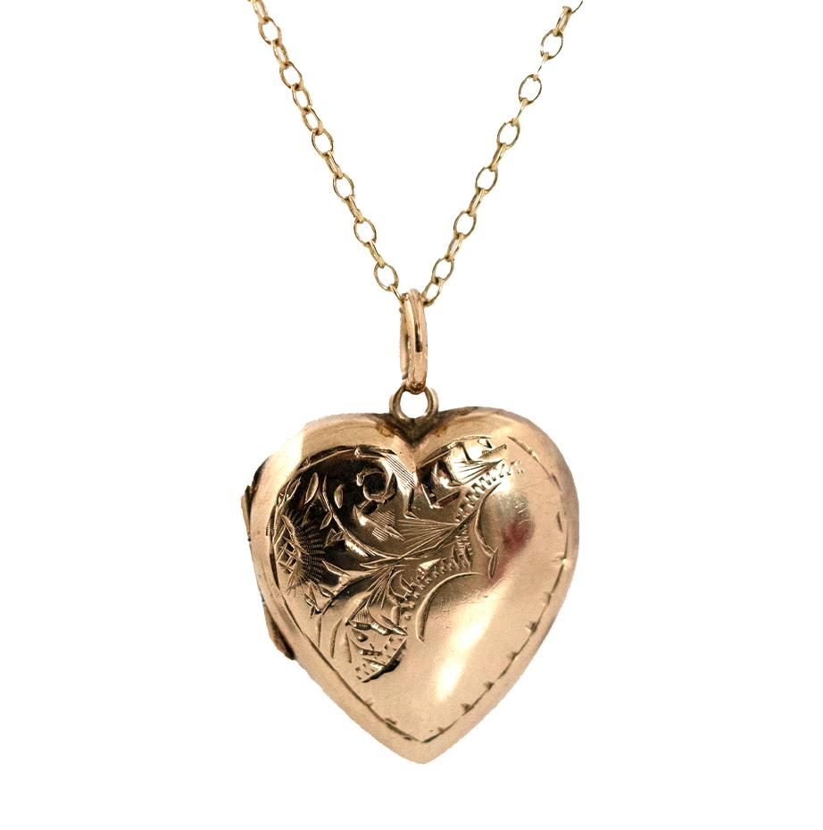 This elegant Victorian heart locket is a timeless keepsake of love and craftsmanship. Made in 9ct yellow gold, its surface is beautifully engraved with flowing foliate scrolls framed by a fine border — a delicate design typical of late 19th-century