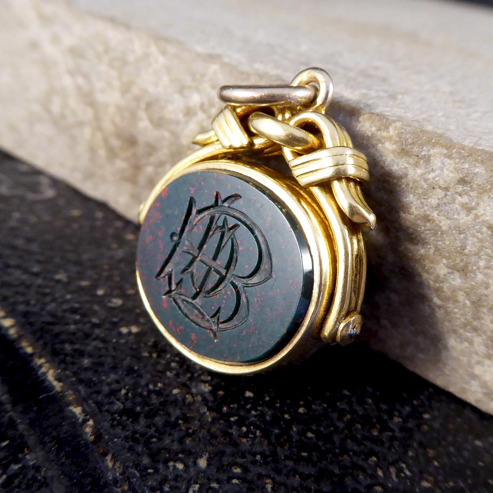 Traditionally found attached to a gentleman's watch chain, which are still worn to this day or hung from a chain as a necklace. This unique antique quality 18ct Yellow Gold spinning fob pendant is set with engraved Bloodstone (for wax seal) and