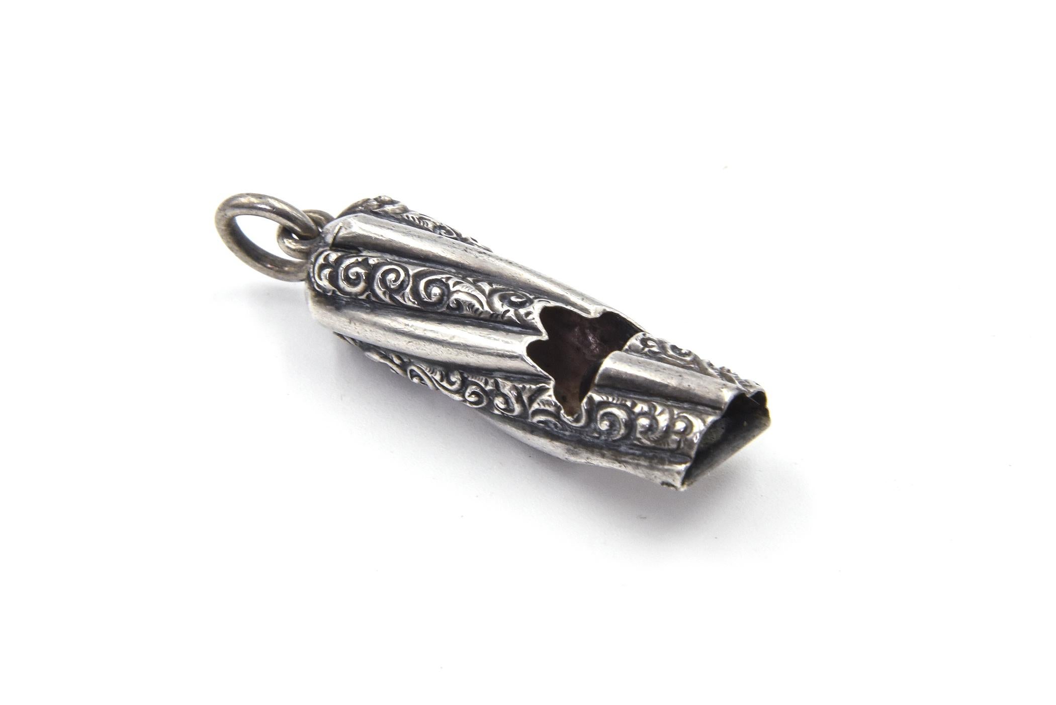 Working delightful sterling silver antique Victorian whistle featuring an engraved and fluted design.  The whistle works.  This piece would be perfect for a necklace, chatelain or even a charm bracelet.
Marked Sterling
Measurement below with bale