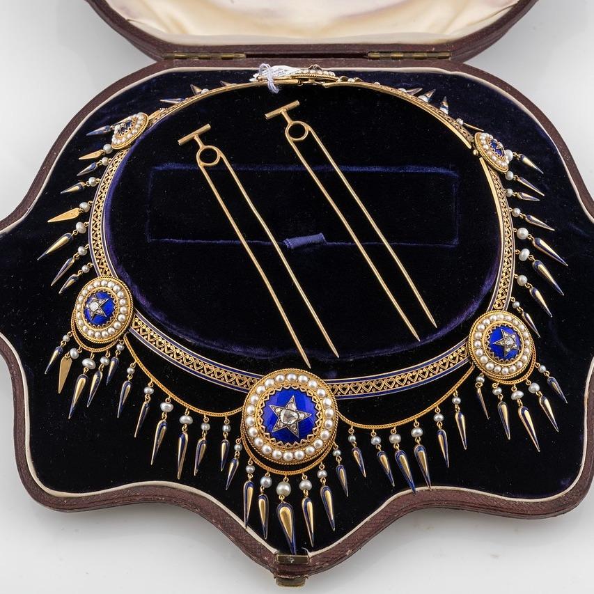 A dramatic English 19th century enamel and diamond  starburst swag necklace in fitted velvet box. This unique piece also includes the fittings to wear the starbursts alternatively as either pins or hair ornaments. 

The star motif is seen often in