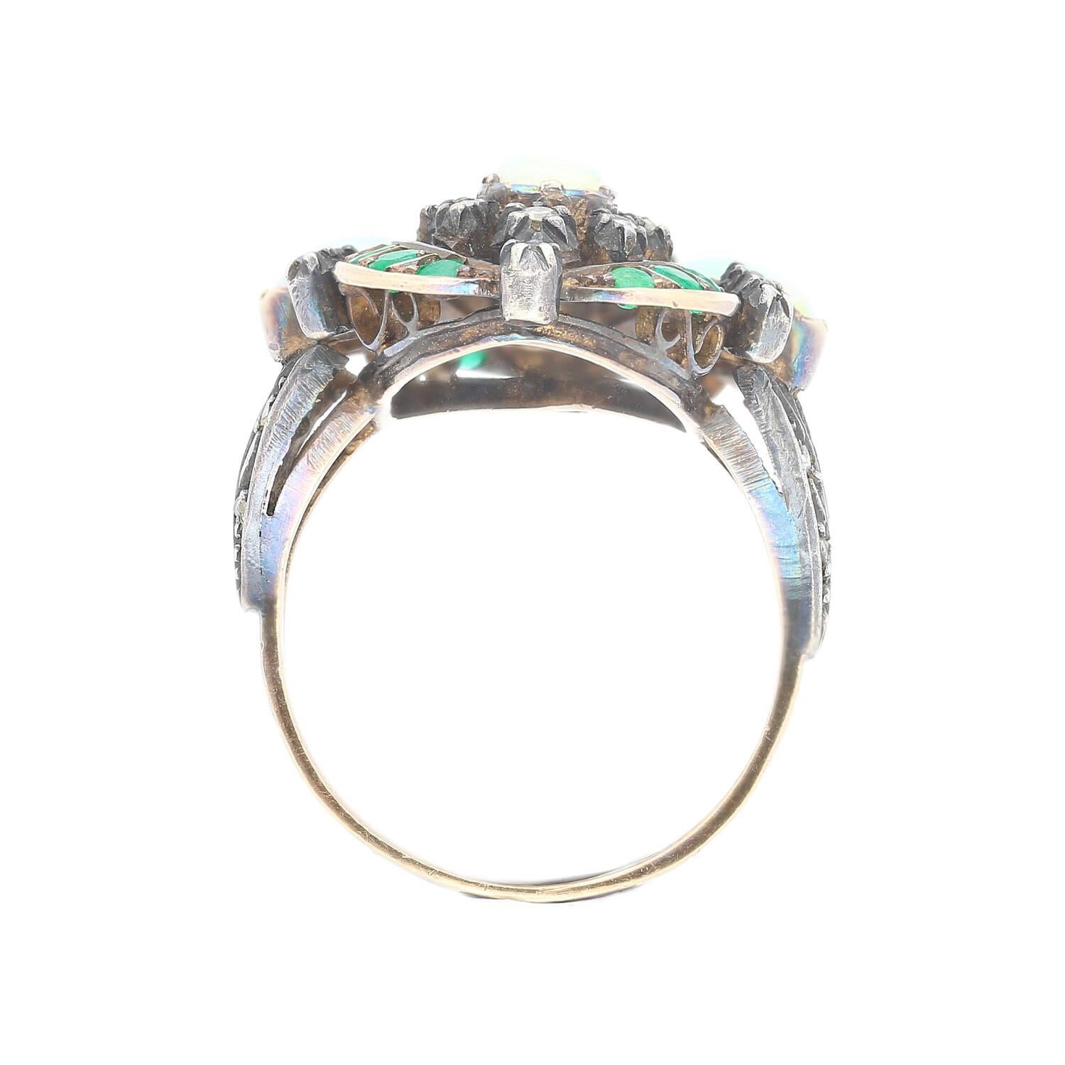 Transport yourself to the refined allure of the Victorian Era with our meticulously crafted Opal Emerald and Diamond Ring. This exquisite cocktail ring showcases prong-set opal stones, along with mesmerizing emeralds and diamonds, elegantly set in a