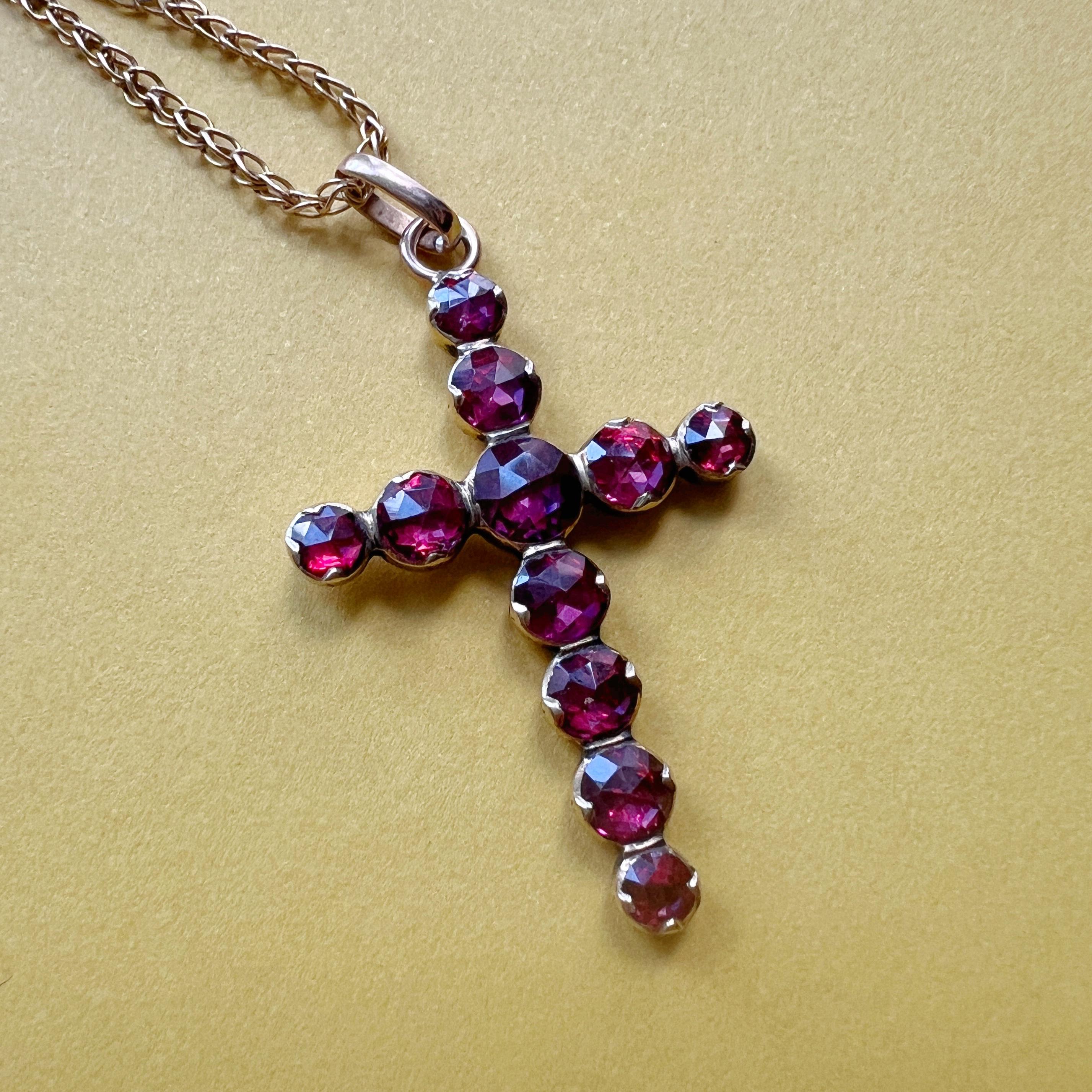 For sale a beautiful 19th century cross pendant made of 10 sparkling Perpignan garnets. The Perpignan garnets, rose cut and foiled back, are renowned for their deep, rich red hue. They lend an enchanting allure to the pendant, creating a stunning