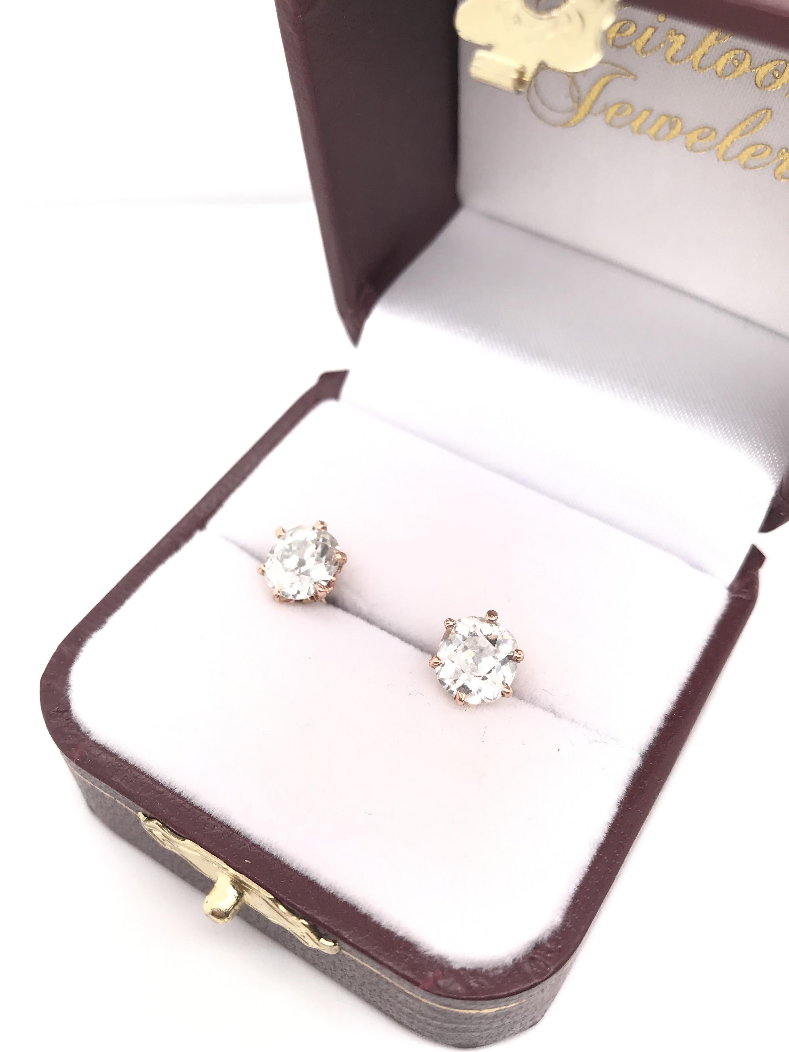 These antique diamond earrings were crafted sometime during the Victorian design period (1840-1900). The diamonds are Old Mine cut, measuring approximately 1.30 carats and 1.29 carats. They have a combined total diamond weight of approximately 2.59