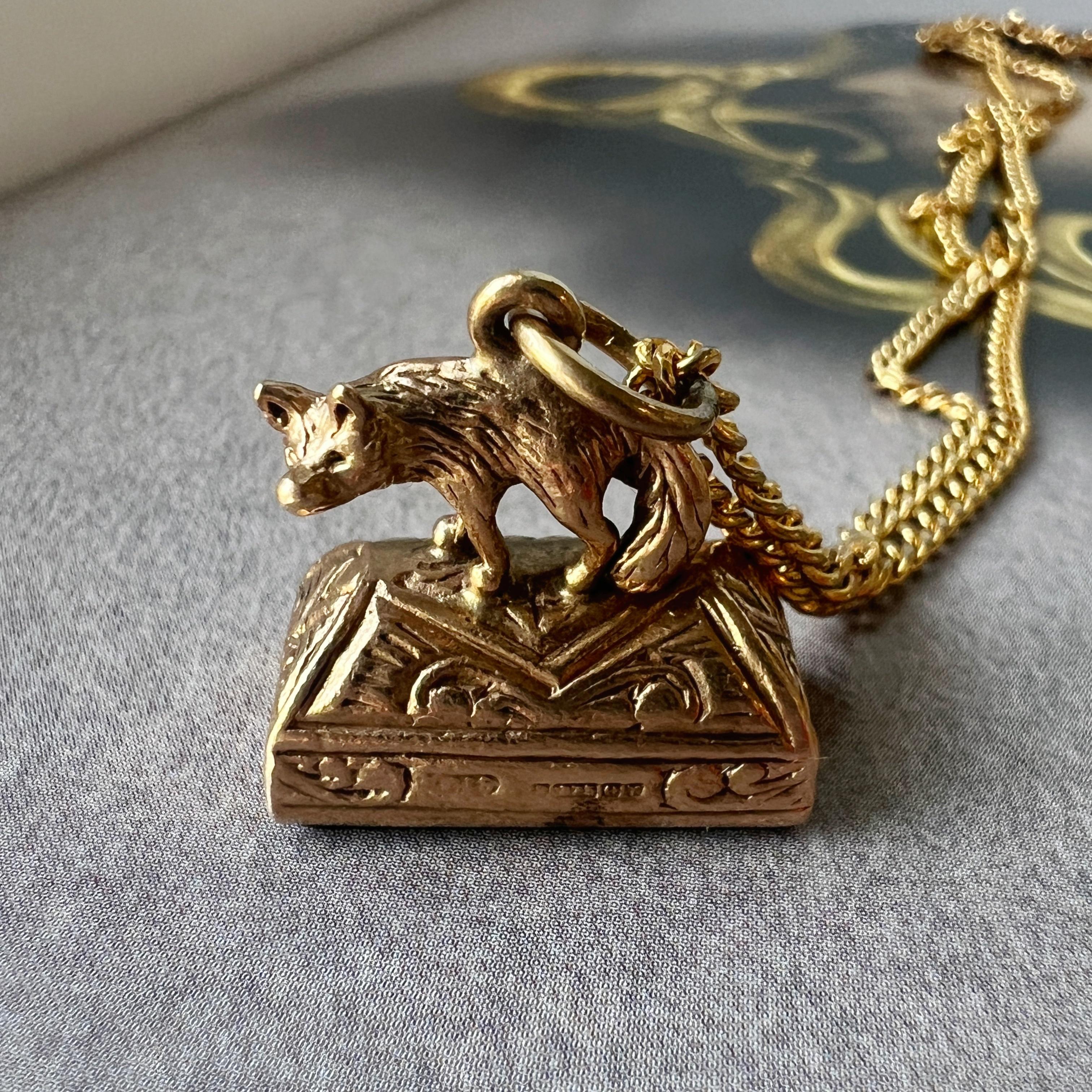 Transport yourself to the charm of the Victorian era with this very cute, English work antique 9K gold fob pendant. Crafted with meticulous attention to detail, it features a captivating fox miniature perched atop a seal made from bloodstone.

The