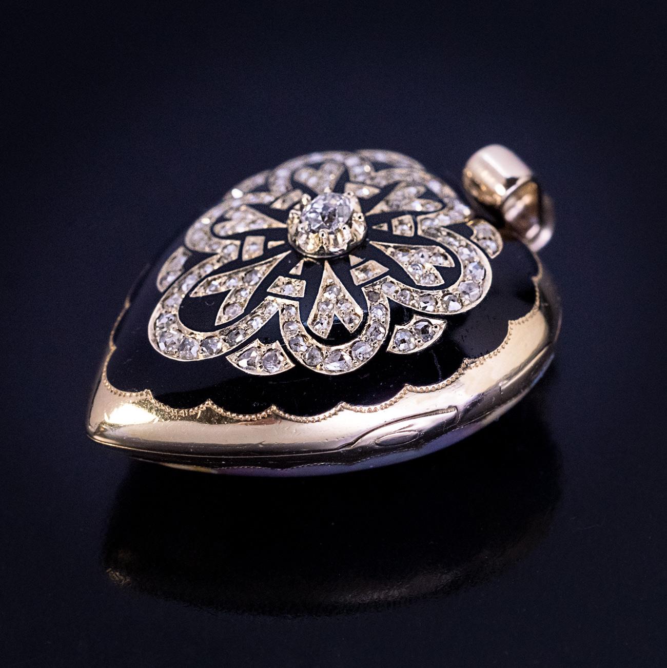 Likely made in Geneva, Switzerland, circa 1850.

A superb quality antique Victorian era 18K gold, heart-shaped locket pendant features a finely painted enamel profile of a female wearing a gold royal diadem, accented by rose cut diamonds.

The