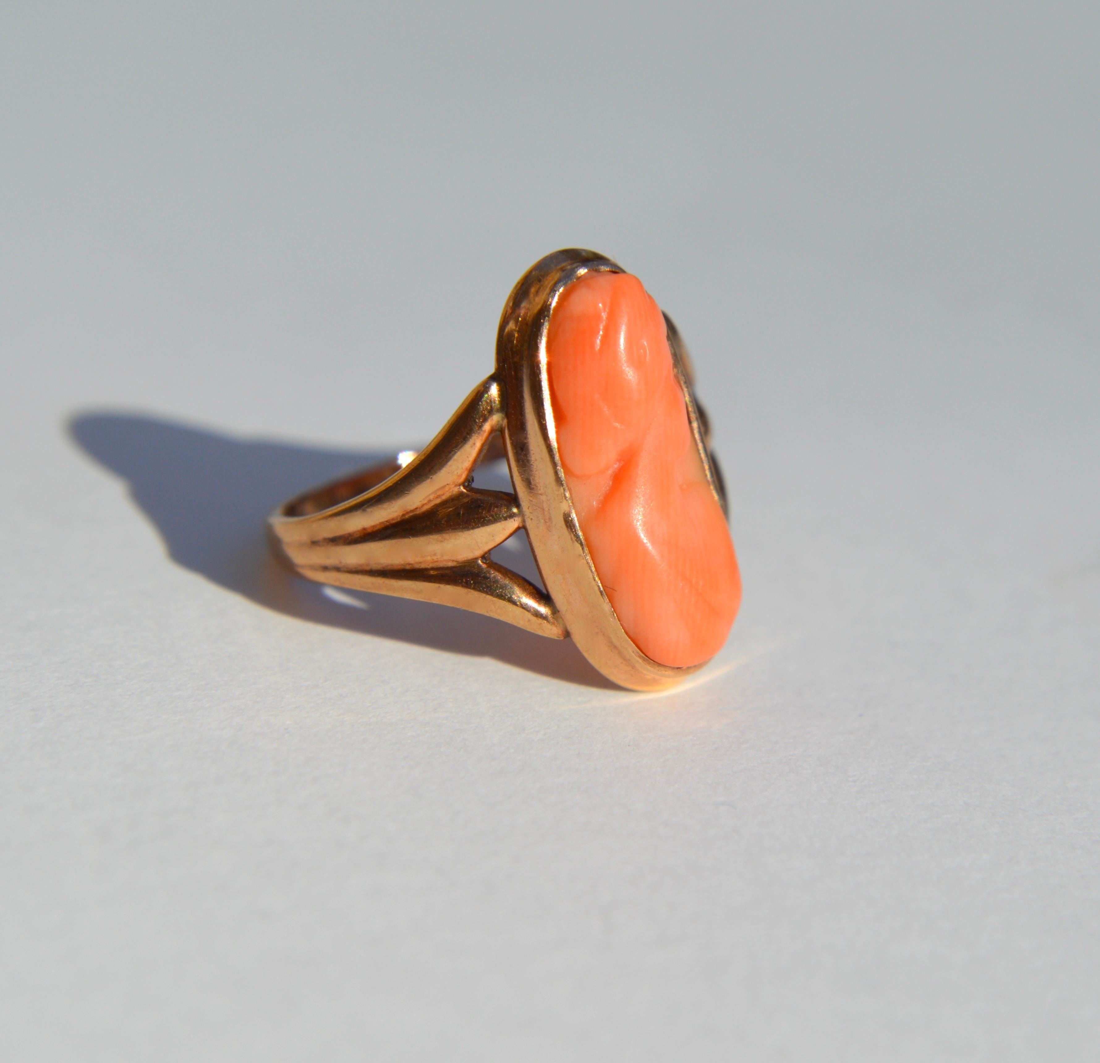 Lovely antique late 1800s Victorian era natural coral cameo portrait of a woman in 14K rosegold Size 4.75. ring is unmarked, but tested as solid 14K. Coral cameo measures 16x8mm. In good condition. Can be resized by your local jeweler. 

Coral