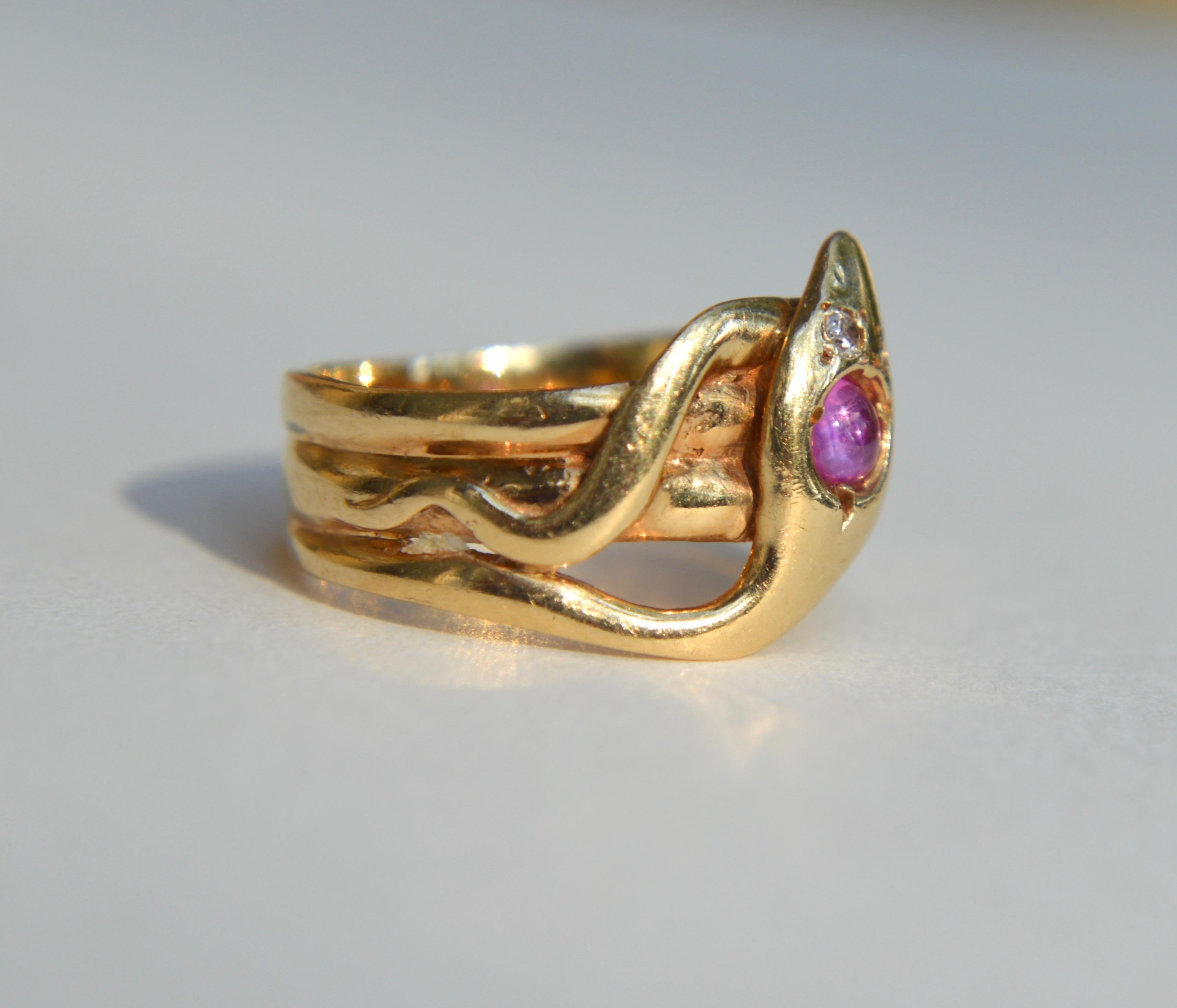 Gorgeous antique Victorian era late 1800s 14K yellow gold with pink sapphire cabochon and round cut diamond snake ring. Size 6.25, not recommended for resizing due to the ribbed band. In good condition. Sapphire cabochon measures 3mm diameter, 0.11