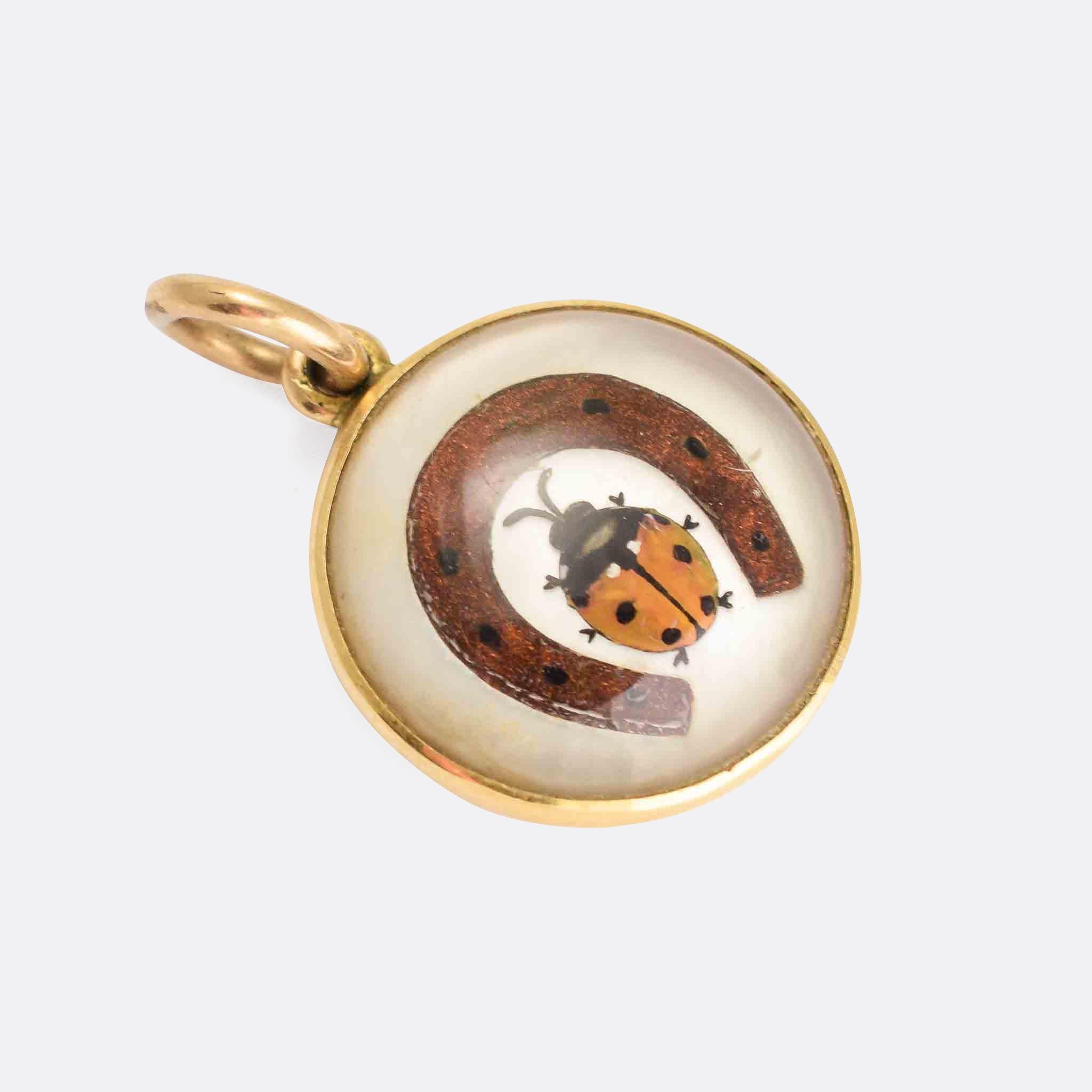 A super cute antique Essex Crystal lucky charm pendant. The rock crystal cabochon has been reverse carved and painted with a ladybird within a horseshoe. It's mounted in 18 karat gold, and dates from the Victorian period, circa 1870.

STONES 
Essex