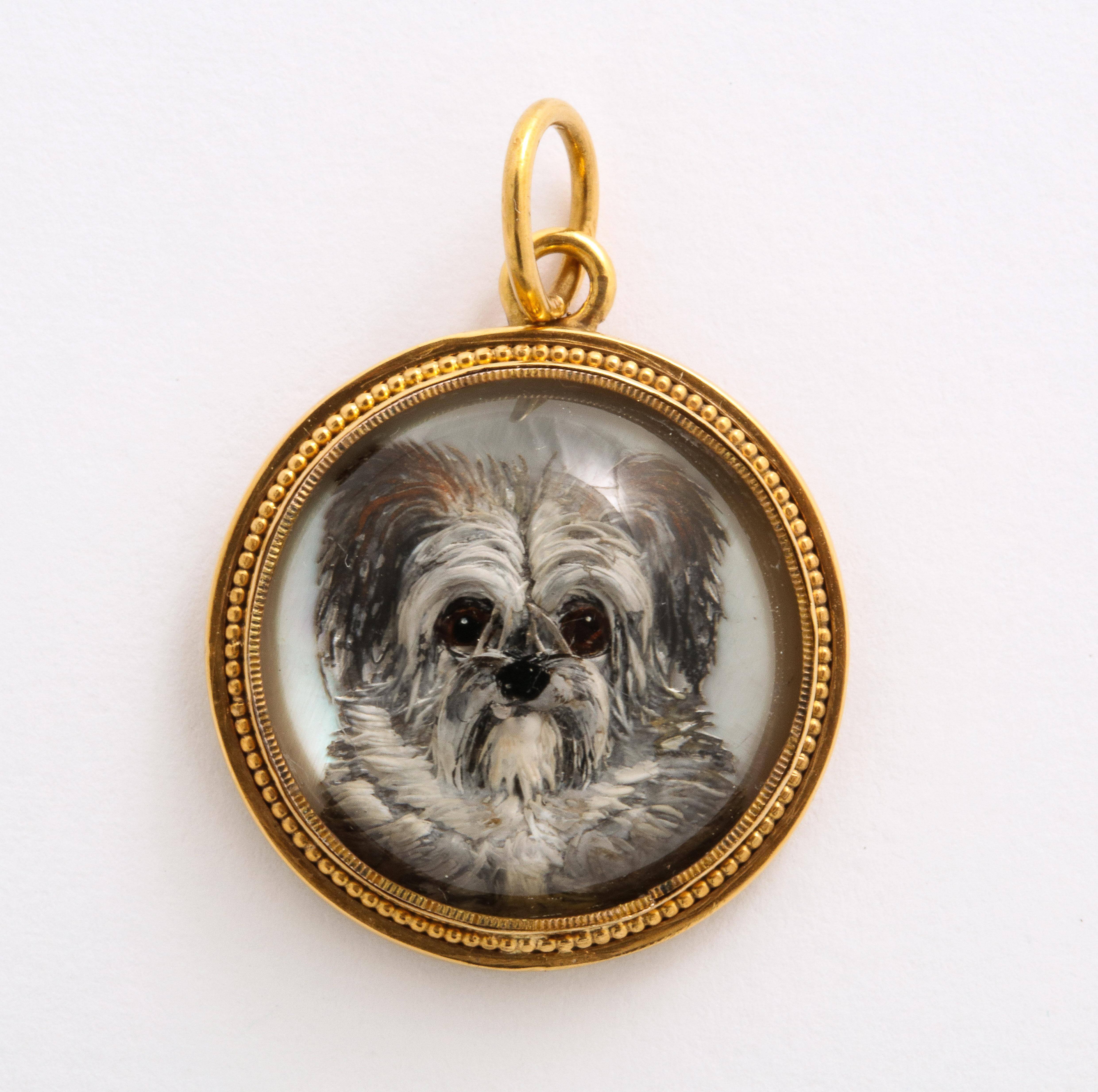 Just look at the face on this pendant of a precious Essex crystal terrier pup set in gold and you will want to hug it. The dogs big round eyes beg your attention. The dog seems to jump from its containment. Essex crystal or reverse crystal intaglio,