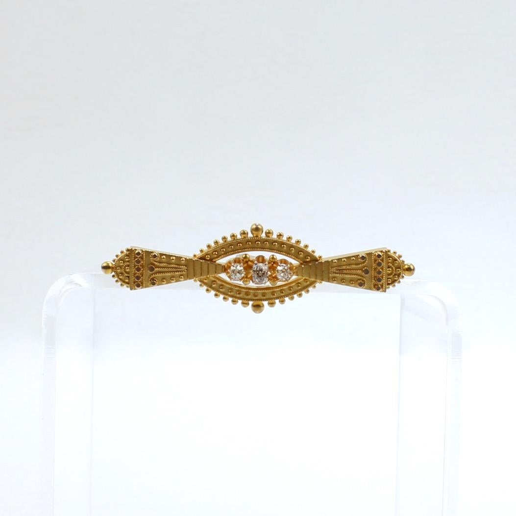 A very fine Victorian Etruscan Revival gold and diamond brooch.

In 14k gold with granulated and wire work decoration. 

Prong set with three diamonds at the center of brooch.  

Simply a finely made Etruscan Revival brooch!

Date:
19th