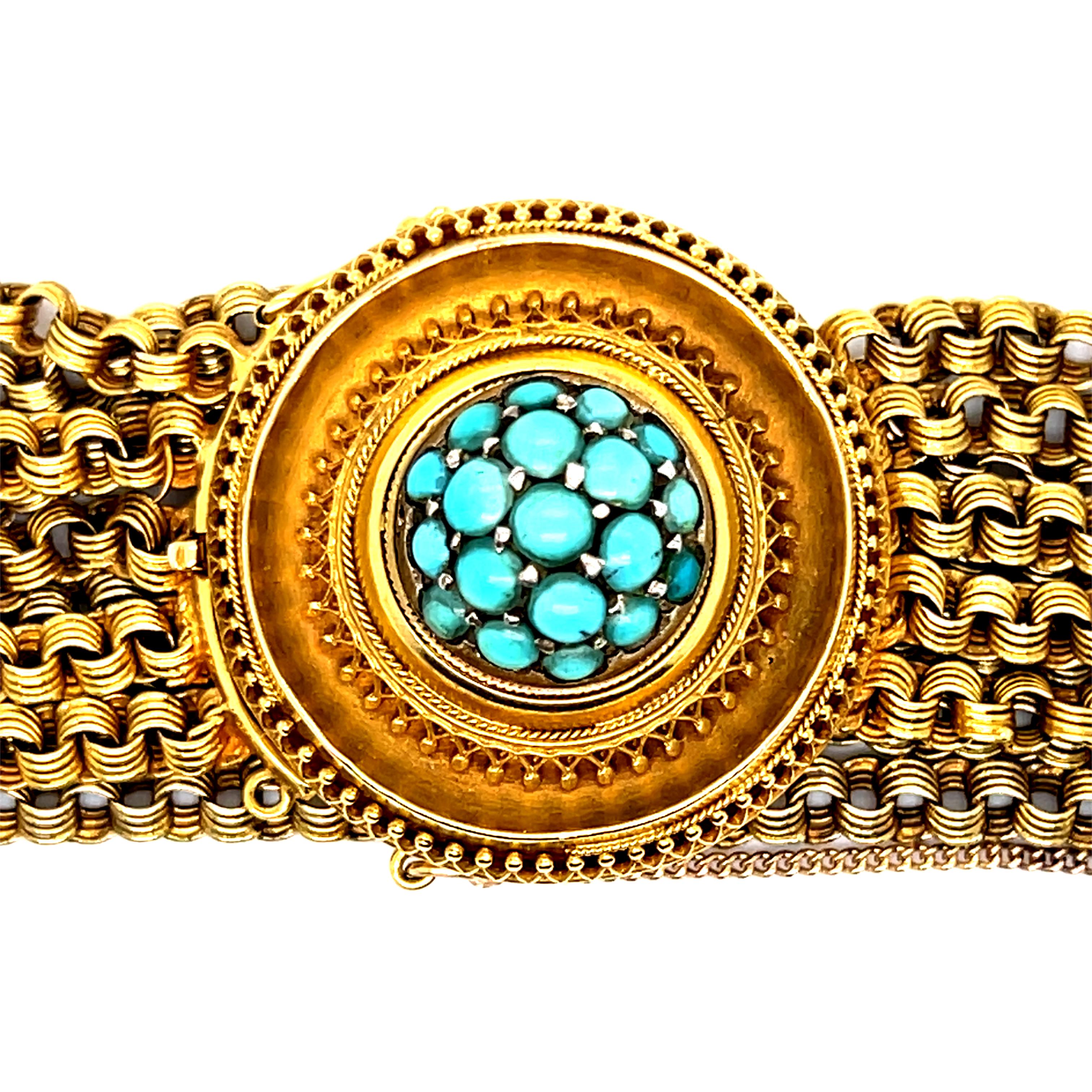 This Stunning Antique Etruscan Revival 18K Yellow Gold and Turquoise Bracelet is a gorgeous one of a kind. Crafted in 18K Yellow Gold circa 1870, the design features 5 chains of gold around the wrist, with a fantastic large gold medallion center,