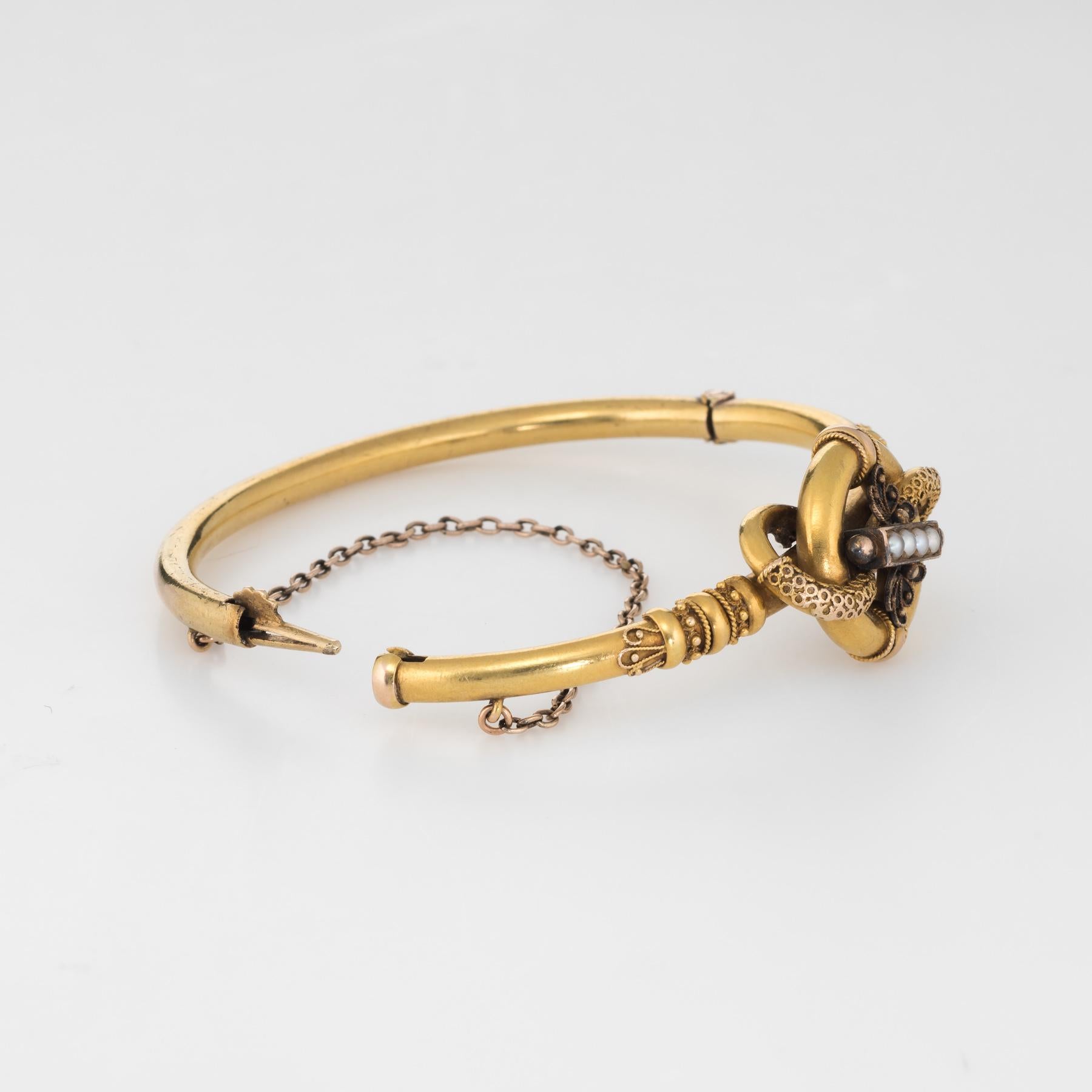Finely detailed antique Victorian bangle bracelet (circa 1870s to 1880s), crafted in 14k yellow gold. 

Four estimated 1.5mm seed pearls adorn the center of the bracelet.    

The bracelet features classic Etruscan revival ornamentation. The center