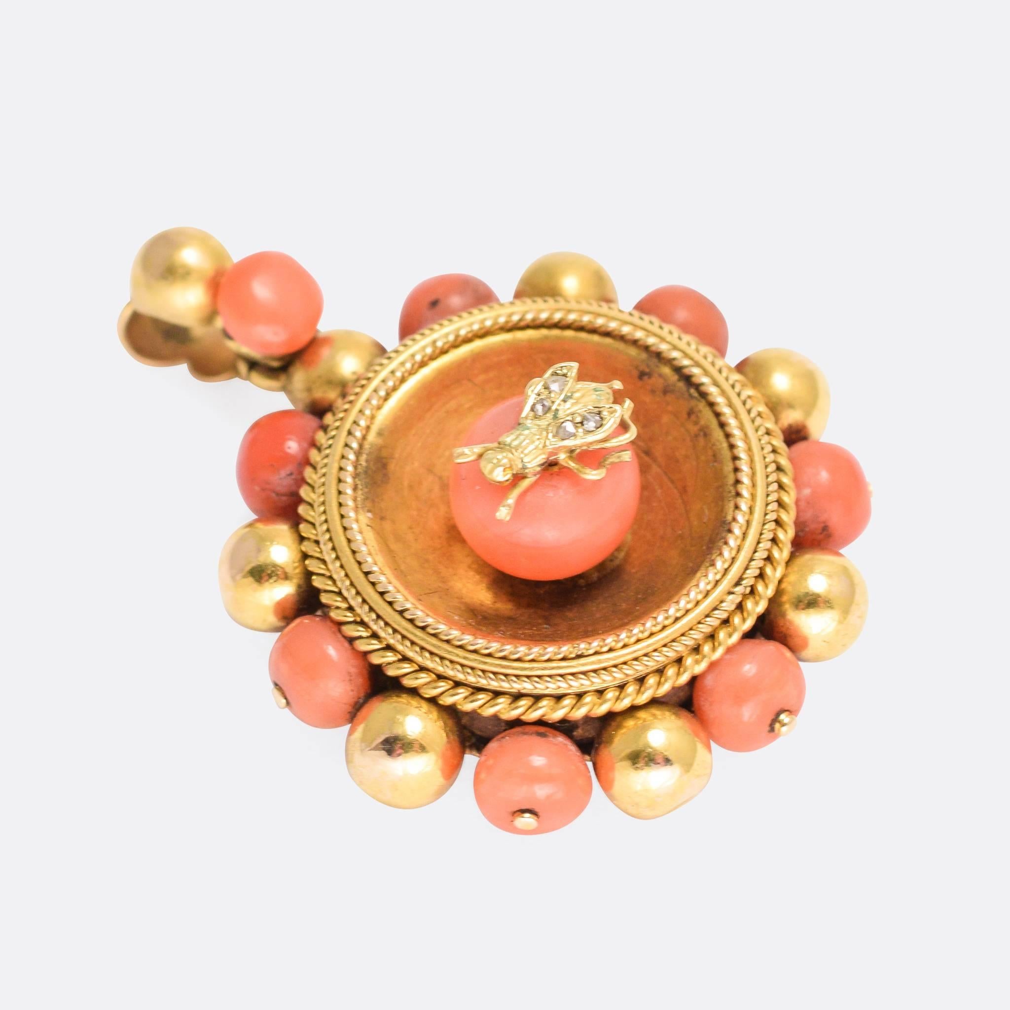 A fine Victorian Etruscan Revival locket modelled in 15k Gold throughout. Incredibly detailed rope work detailing around the centre, coral beads and gold balls to the edge, and the centre piece - a diamond set fly on a larger piece of natural coral.