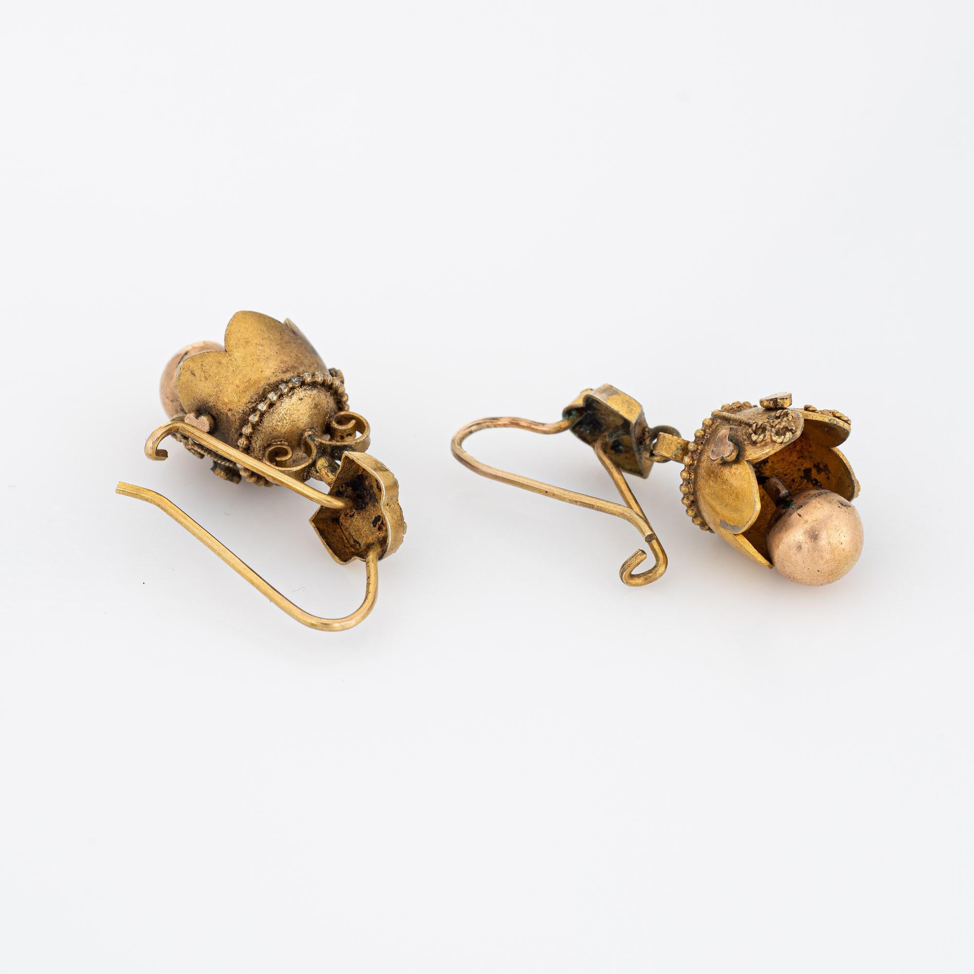 Elegant pair of antique Victorian earrings (circa 1880s to 1900s) crafted in 10k yellow gold. 

The charming Etruscan revival earrings feature scalloped drops with beaded, granulation and rope detailing. The base of the earrings moves with a light