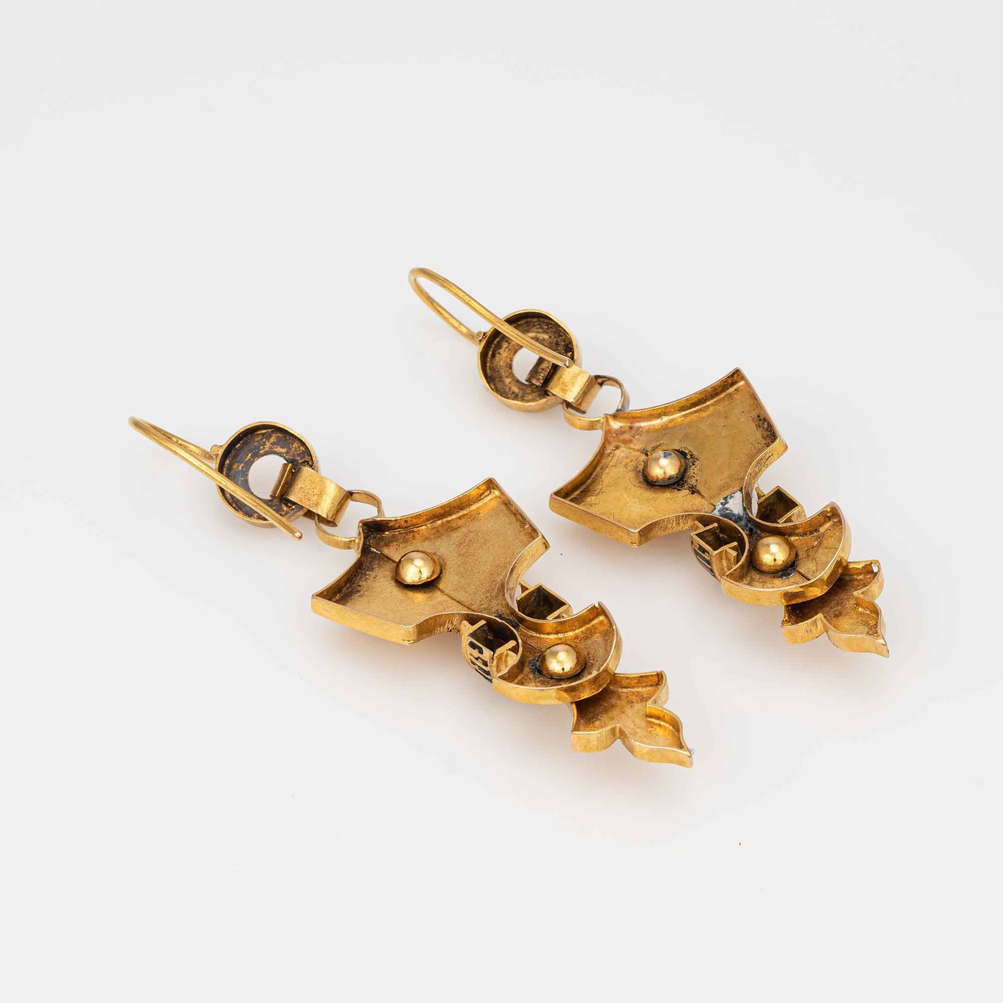 Elegant pair of antique Victorian Etruscan earrings (circa 1880s to 1900s) crafted in 18k yellow gold. 

The charming earrings feature hand-crafted fleur de lis metal work with applied enamel panels (enamel loss present).  With patina evident the