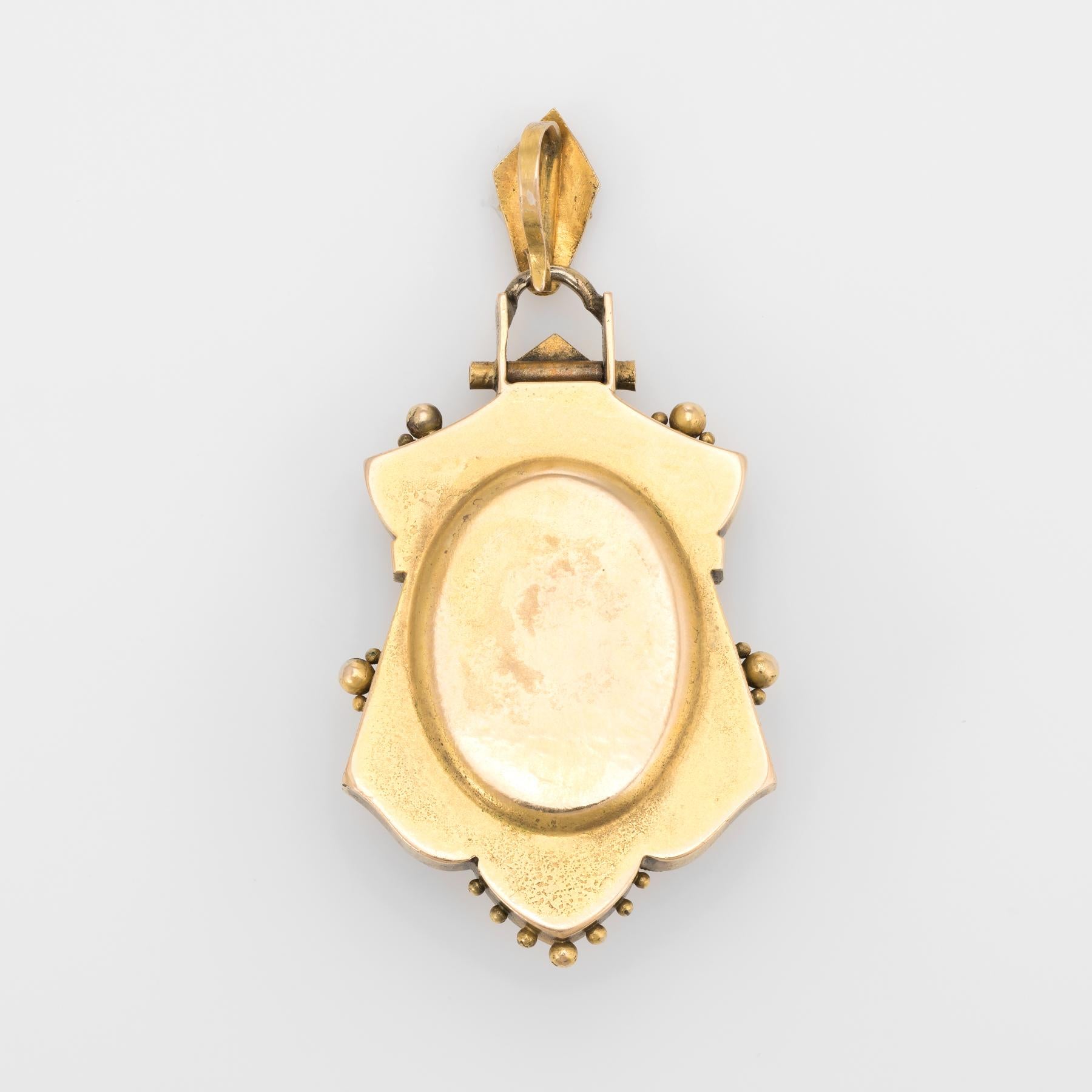 Finely detailed antique Victorian era pendant (circa 1870s to 1880s), crafted in 14 karat yellow  gold.  

Five 1.5mm seed pearls are set into the mount. Note: slight color variance to the pearls from wear and age.  

The stylish pendant features a