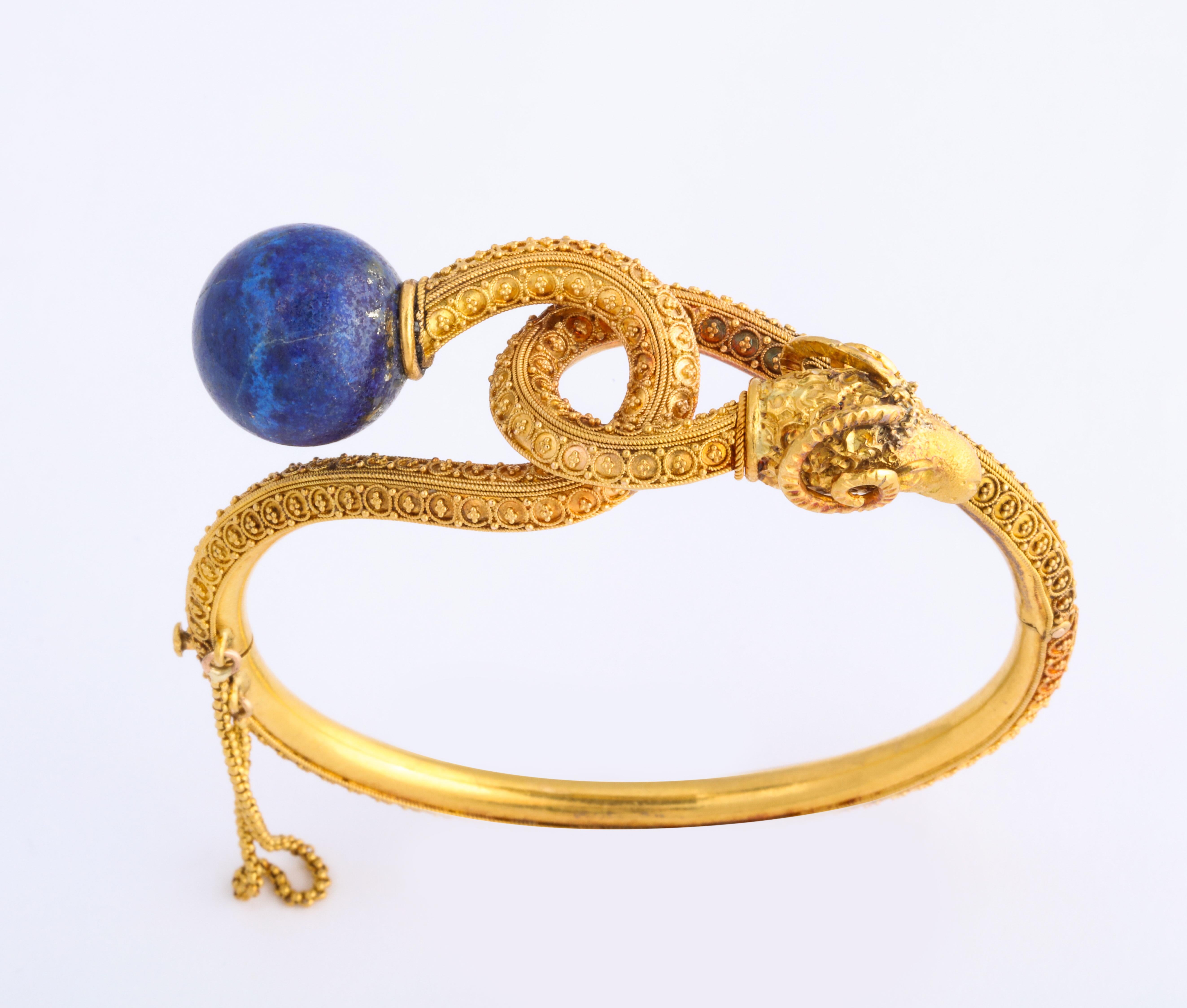 Equal in quality to the gold jewelry of Castellani and Giuliano, a treasure, and one of the finest antique pieces I have ever discovered, this high karat, fully granulated bangle,  crafted with a  knot motif,  Lapis Lazuli and a Ram's Head, is