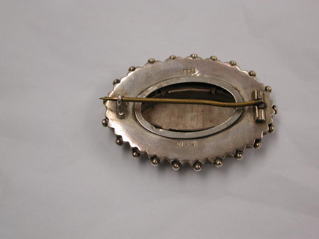 Antique Victorian  Etruscian Silver Brooch with engraved oval 9ct Centre, dated circa 1880
Typical etruscian style of the 1880's
Made by Arthur Johnson Smith of Birmingham.