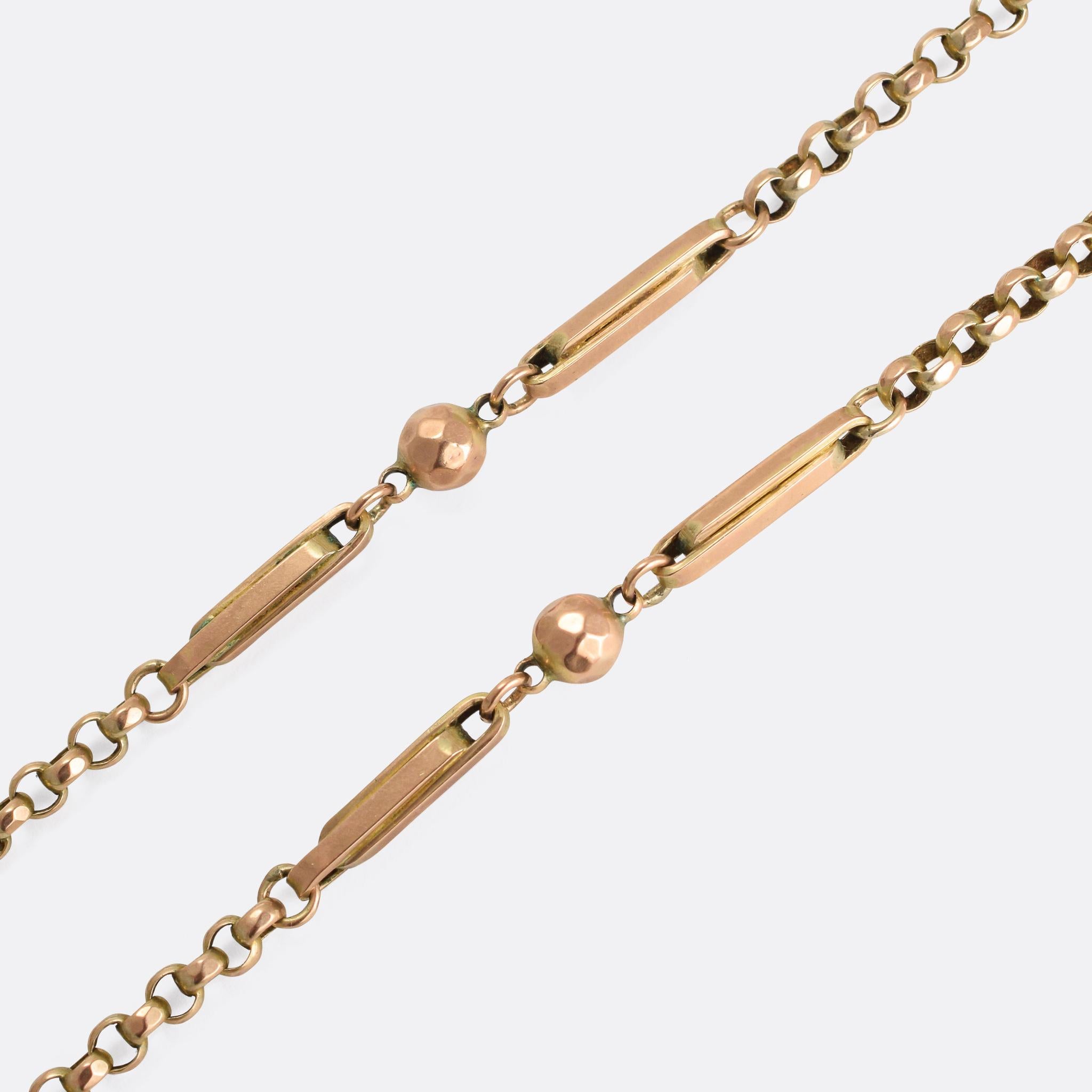 A fine gold fancy-link guard chain. It was made in the latter half of the 19th Century, and features elegant ball and bar embellishments to the faceted belcher links. It's just shy of 60 inches in length, and 32.6 grams of solid 9k