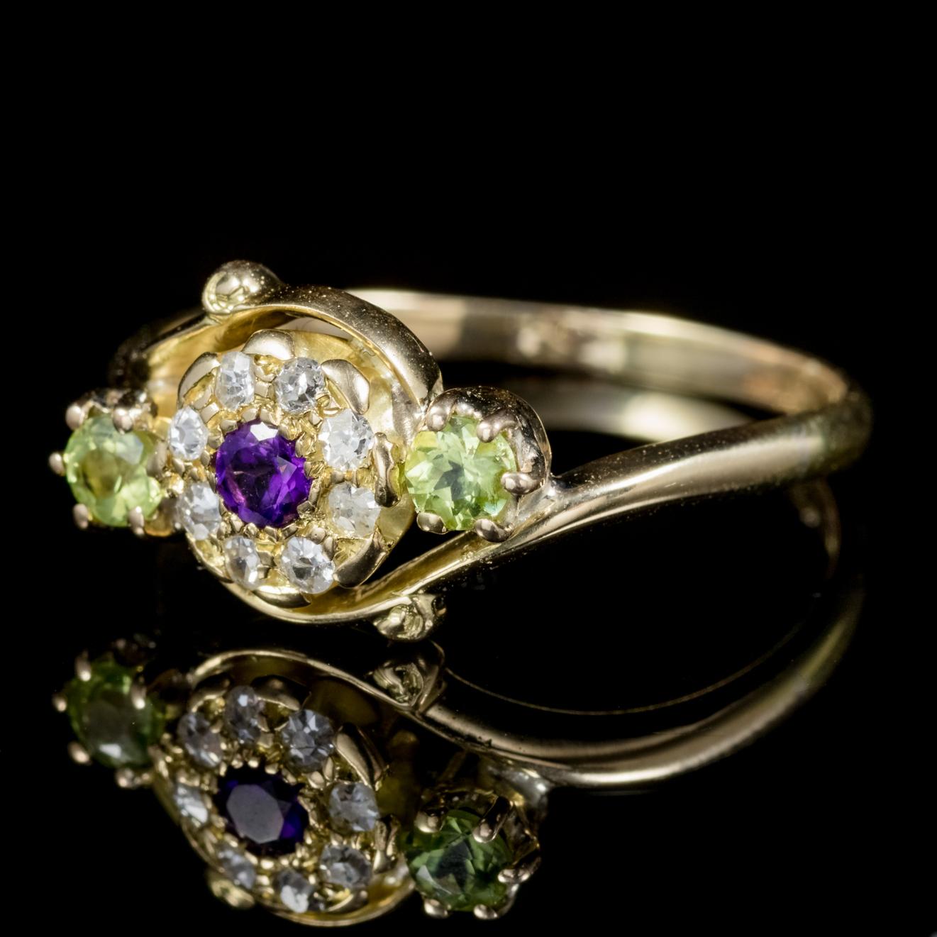 A fancy antique Victorian Suffragette ring C. 1900, set with a violet 0.09ct Amethyst in the centre, flanked by two 0.09ct Peridots and a halo of Diamonds which are 0.02ct each. 

Suffragettes liked to be depicted as feminine, their jewellery
