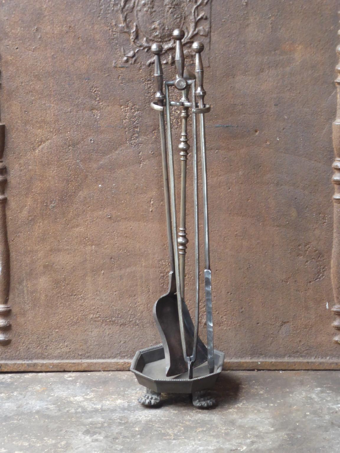 19th century English Victorian fireplace tool set made of cast and wrought iron. The tool set consists of three tools and a stand. The condition is good.













  