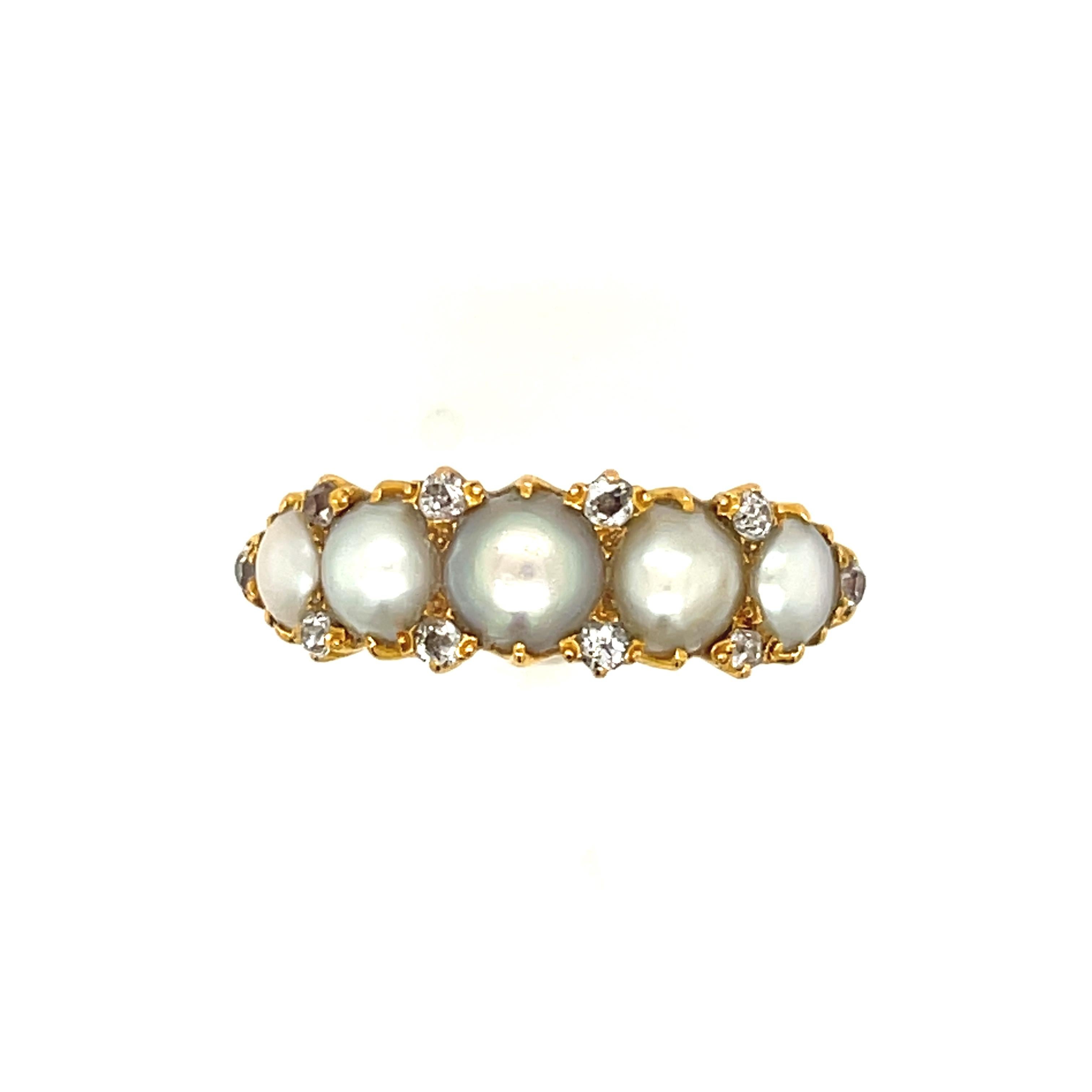 A wide antique Victorian five pearl half hoop ring accented by diamonds circa 1880. The pearls are likely natural and are split to create the ring. The pearls have a nice creamy white lustre with perhaps a slight tinge of gray. The 10 diamonds are
