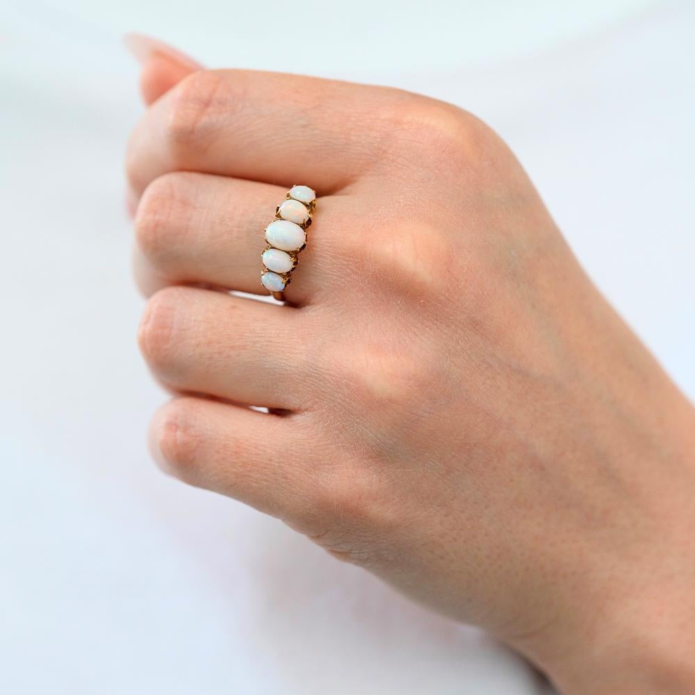 A luminous and romantic piece from the late Victorian era, this five-stone opal ring captures the era’s deep fascination with symbolic and ethereal jewellery. Crafted in solid 18ct yellow gold, the ring showcases a graduated row of glowing opals —
