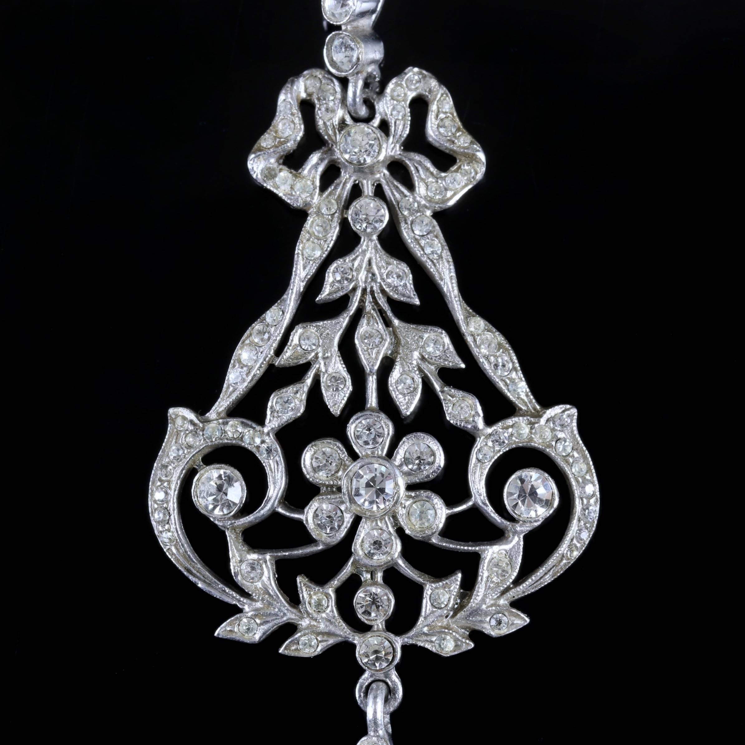 This beautiful Victorian Silver Paste floral pendant is Circa 1900.
 
The wonderful pendant is decorated in sparkling white Paste Stones in a floral style gallery.

Paste is a heavy, transparent flint glass that simulates the fire and brilliance of