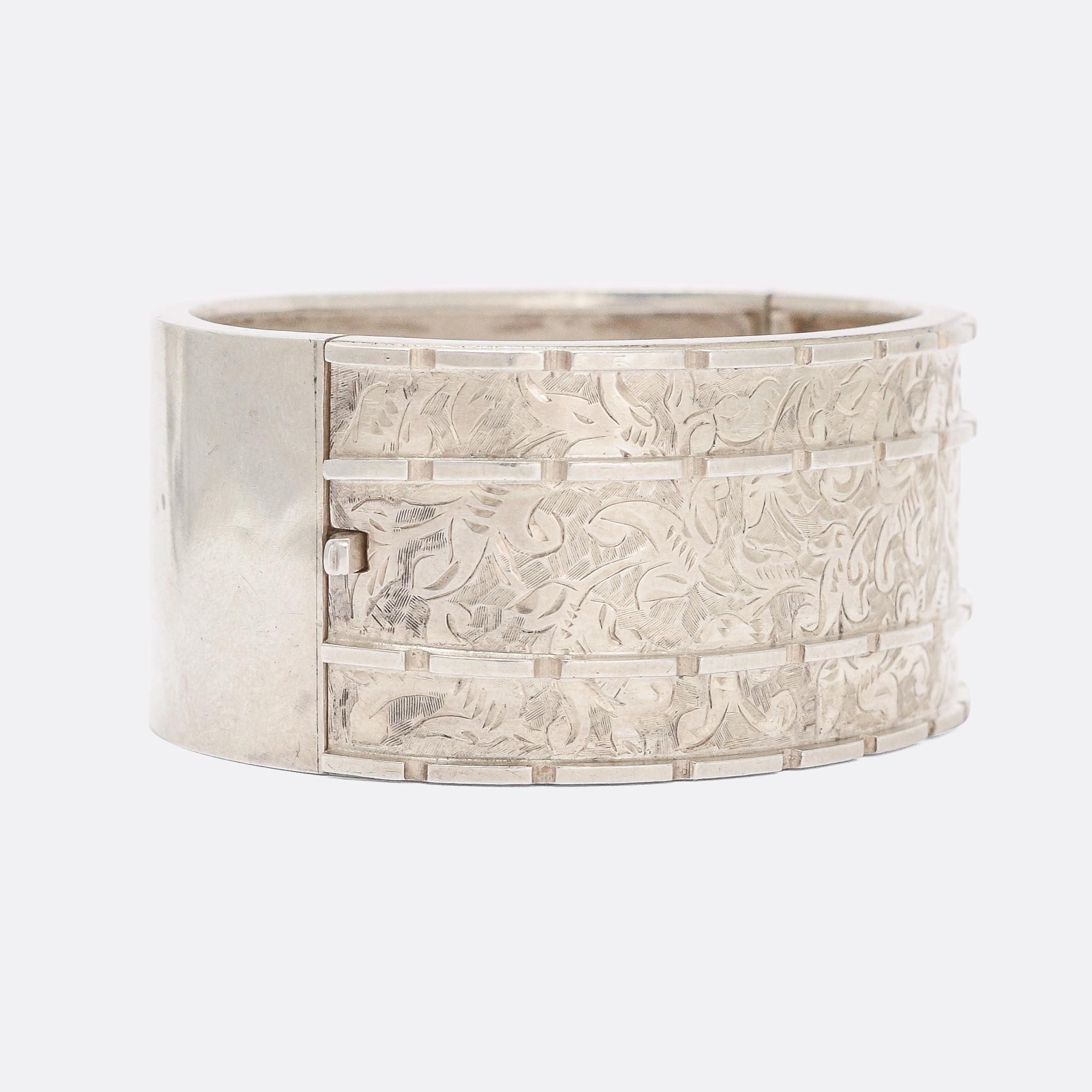 A superb Victorian cuff bangle modelled in sterling silver with a masterclass in hand-chased detailing. It's decorated with intricate foliate motifs, and modelled in Sterling Silver throughout - dating from the 1880s.

MEASUREMENTS
Width: