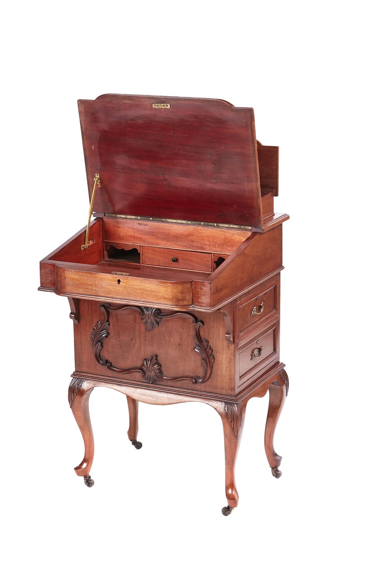 Antique Victorian freestanding walnut davenport having a lift up lid with fitted interior, shaped writing surface, elegantly carved front. Two drawers to the right hand side with original brass handles. Two false drawers to the left side with