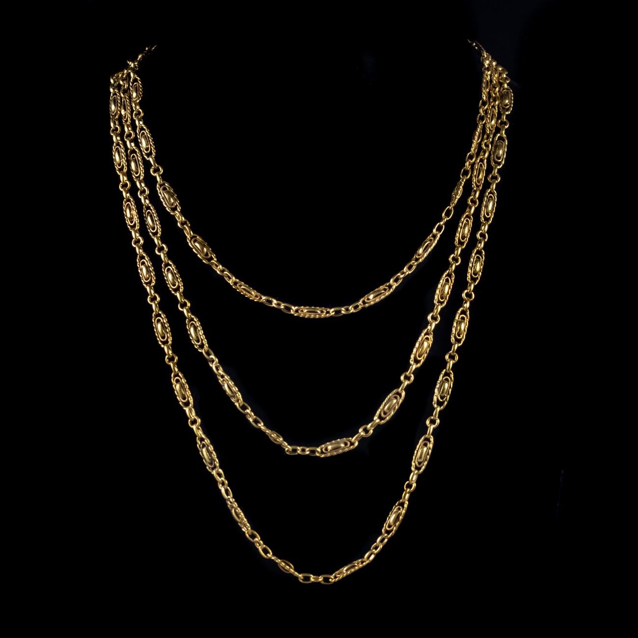 This beautiful Antique Victorian French long guard chain has been modelled in Silver gilded in 18ct Yellow Gold. It features elaborate double oval links spaced around the chain and a large ring clasp to hold it securely when worn.

It has aged