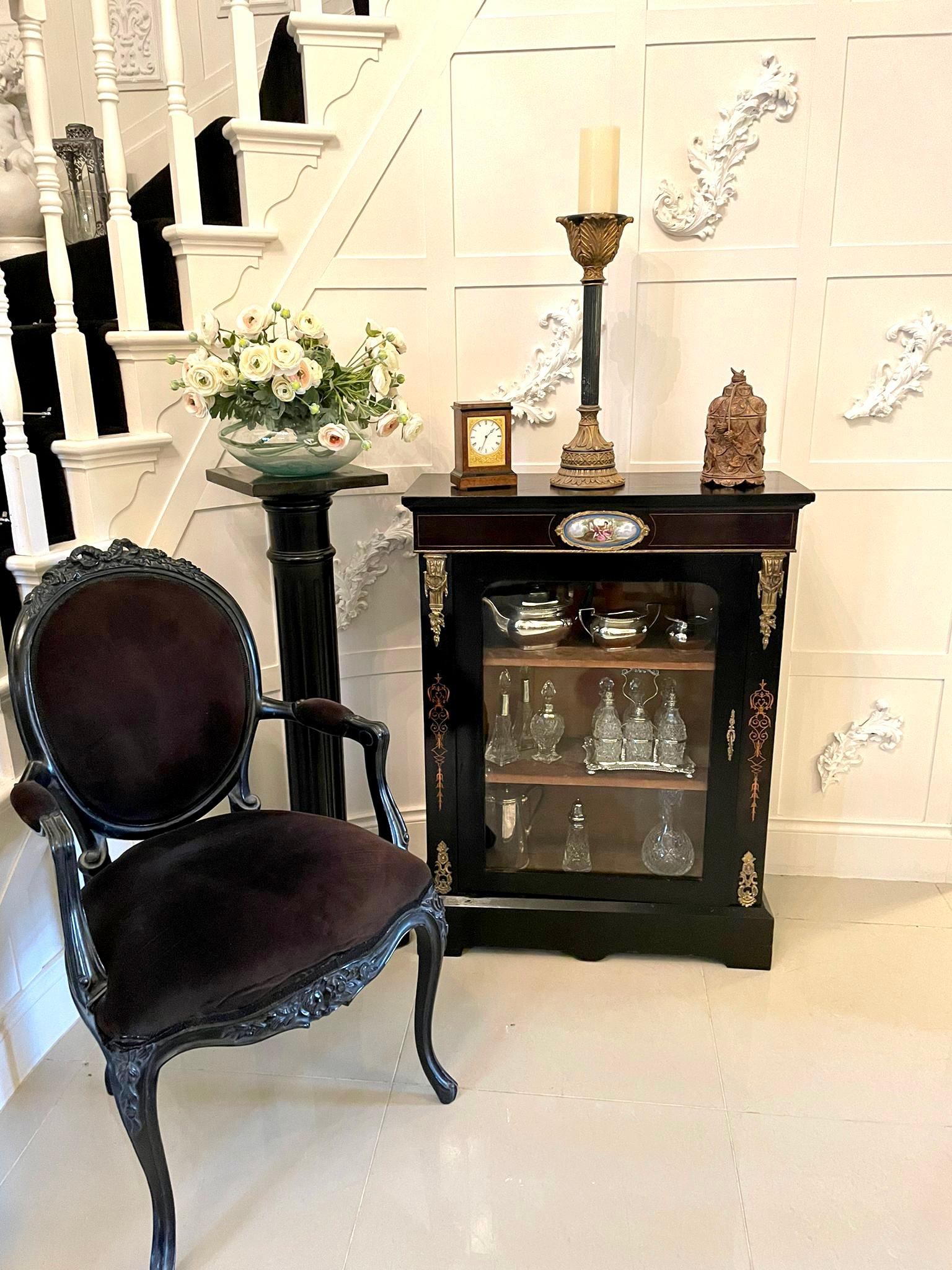 Antique Victorian French display cabinet having an ebonised top, pretty quality oval sévres style plaque to the frieze, lovely ornate brass mounts, boxwood inlay, single glazed door opening to reveal the original fitted interior and standing on a