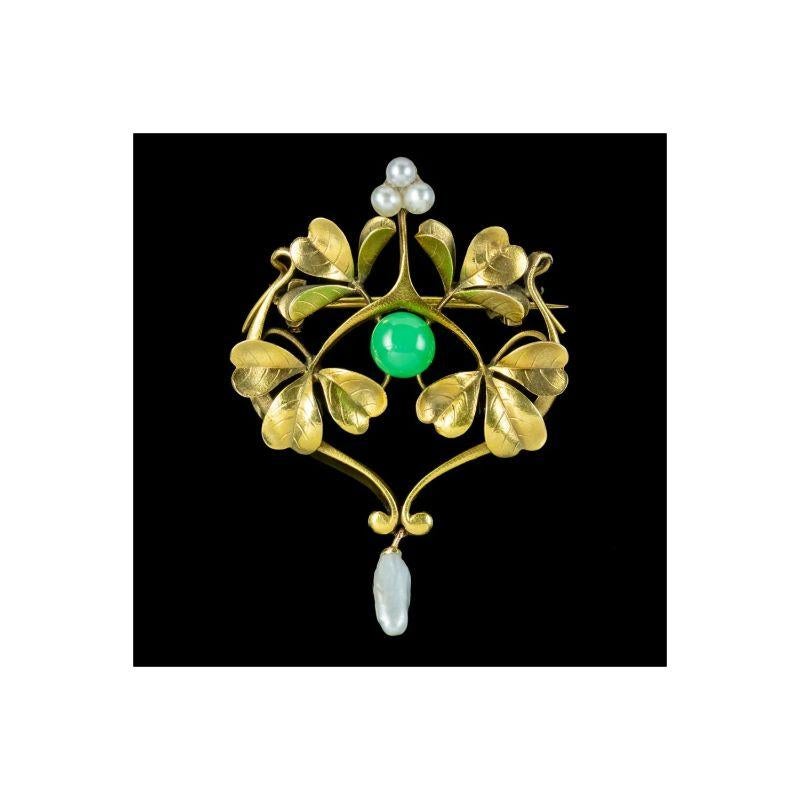 A beautiful antique French brooch from the late 19th Century featuring a fabulous open-work gallery consisting of three large shamrocks with a trilogy of natural pearls at the top, a polished jade sphere in the centre and a long baroque pearl