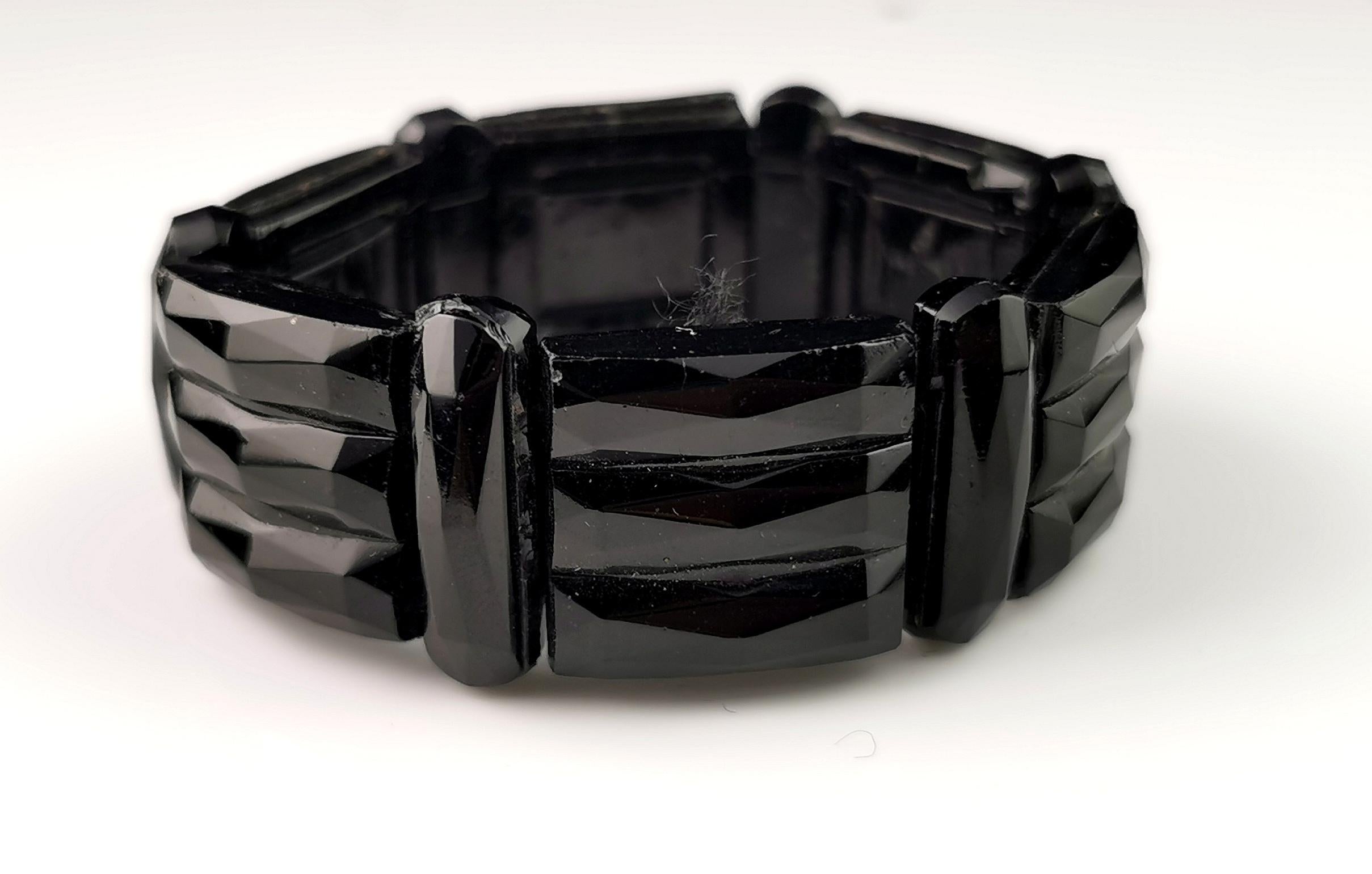 A gorgeous antique Victorian era French jet bracelet.

Carved and engraved panels of rich shiny black French jet are strung onto an elastic thread.

It is a bangle type bracelet and it does have some stretch to it being on elastic.

French jet is
