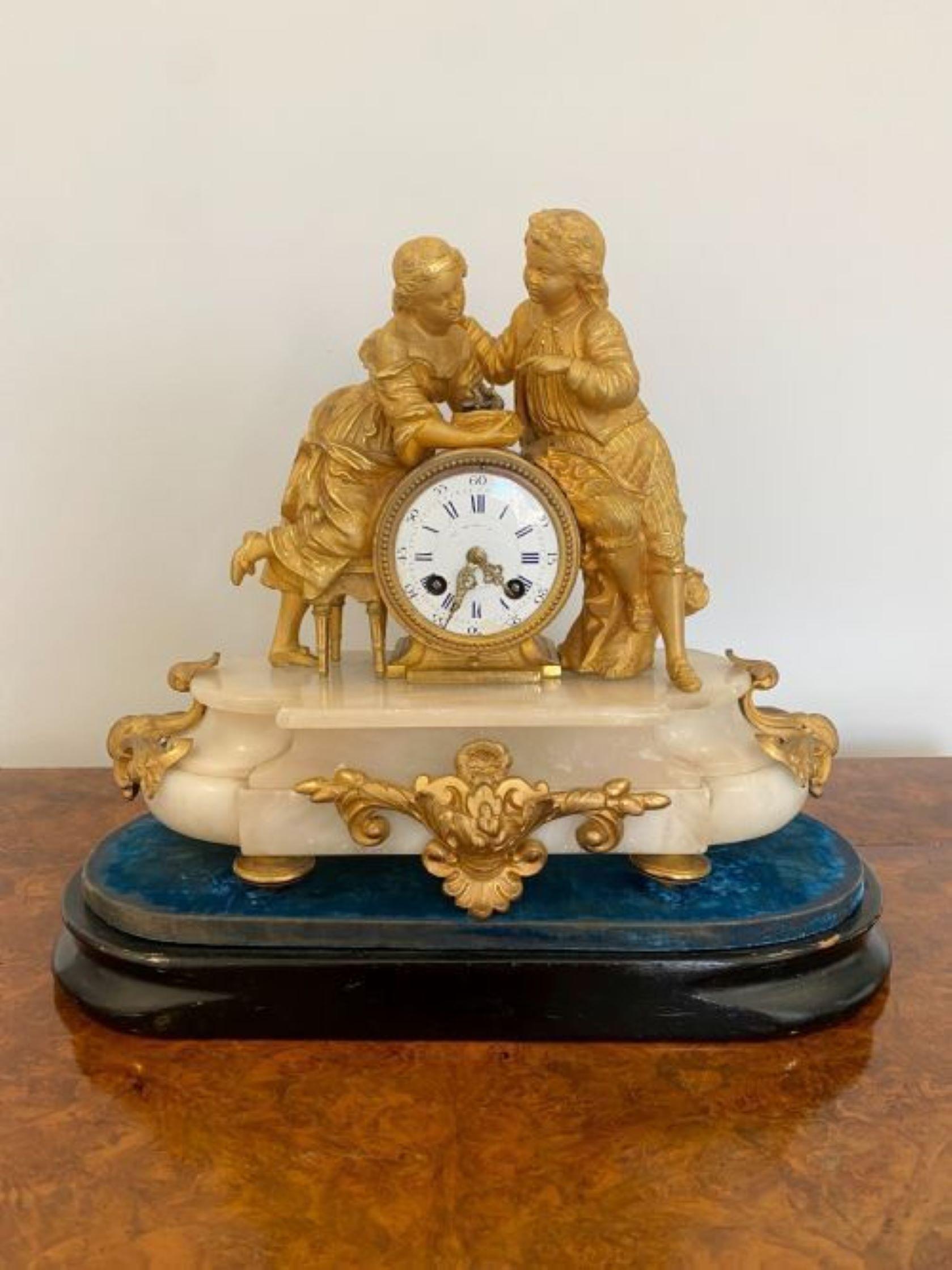 Antique Victorian French ornate ormolu and alabaster mantle clock having a quality pair of ormolu figures holding a birds nest over a circular porcelain dial with original hands, 8 day movement striking the hour and half hour on a bell raised on a
