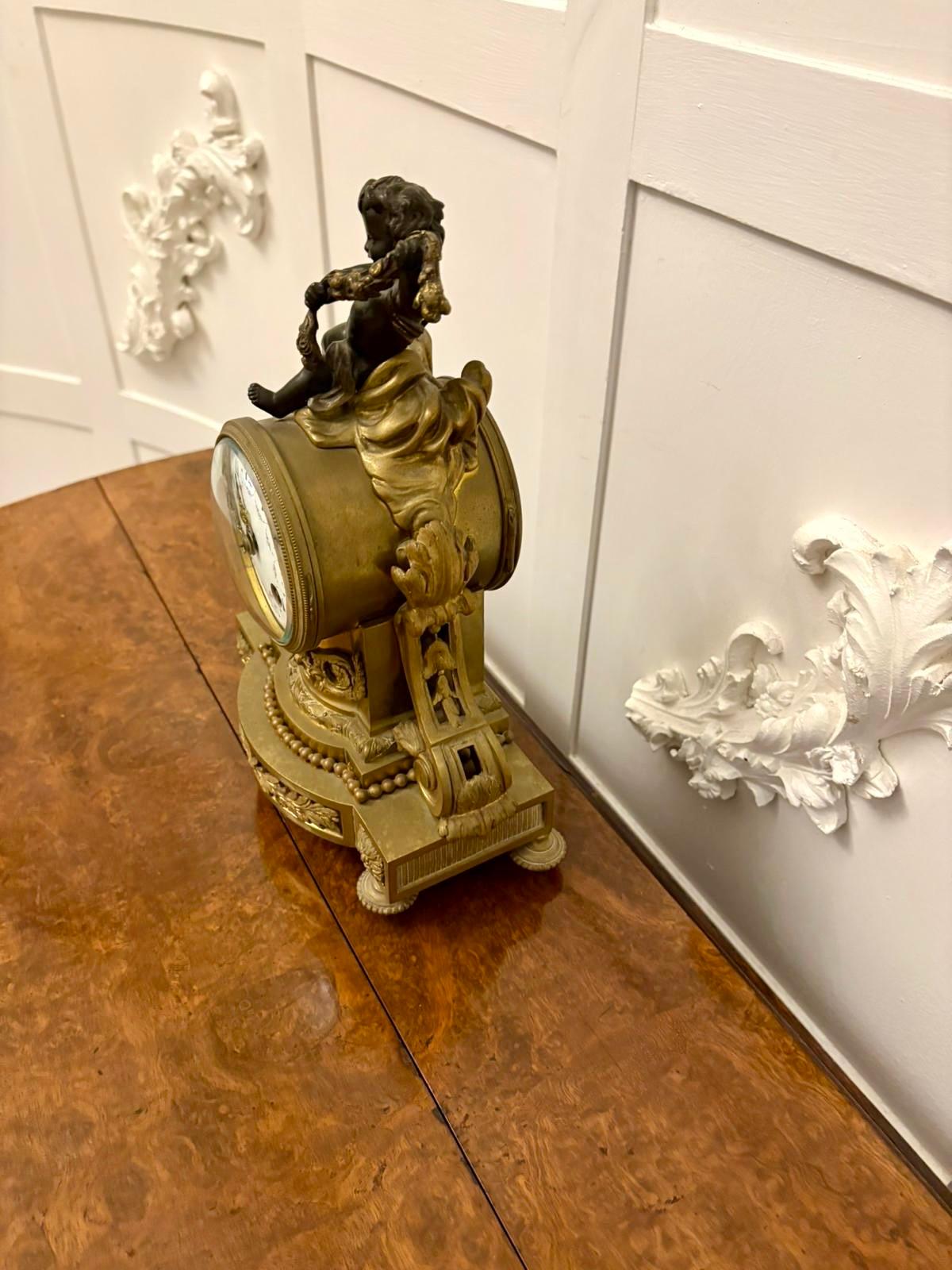 Antique Victorian French quality ornate ormolu and bronze mantle clock having a quality bronze cherub to the top ornate ormolu case with scroll, bow and leaf decoration, circular hand painted porcelain dial, original hands, 8 day French movement