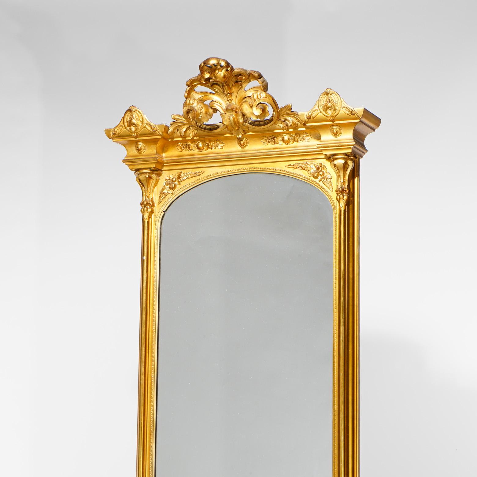 A French Louis XVI style hall pier mirror offers giltwood frame with foliate form cartouche over mirror seated on base with shaped marble top and raised on cabriole legs, foliate elements throughout, circa 1870

Measures - 86.5