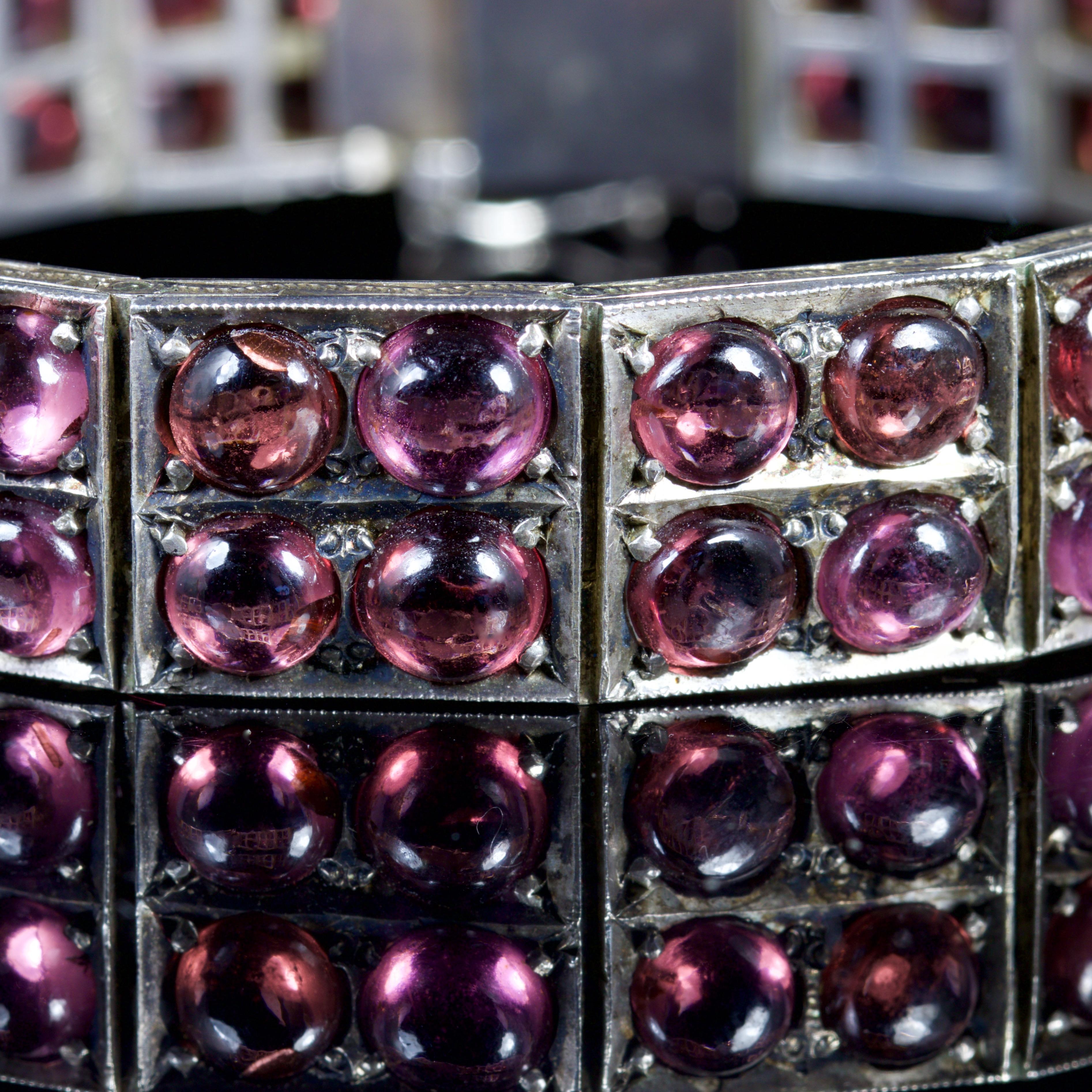 This fabulous Victorian Silver Garnet bracelet is Circa 1880.

The bracelet is adorned with beautiful Almandine Garnets which are set into each panel.

There is over 30ct of Almandine Garnets set into this beautiful bracelet.

Each Garnet is