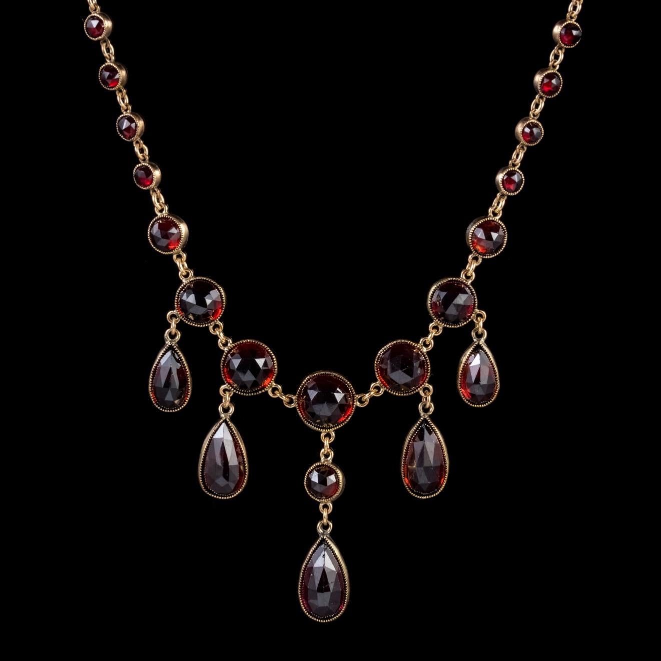 A remarkable Antique Victorian necklace decorated with beautiful deep red briolette cut Garnets milligrain set in Gold with five gorgeous droppers hanging in the centre.

Garnet has been adored throughout history for its blazing red colour which