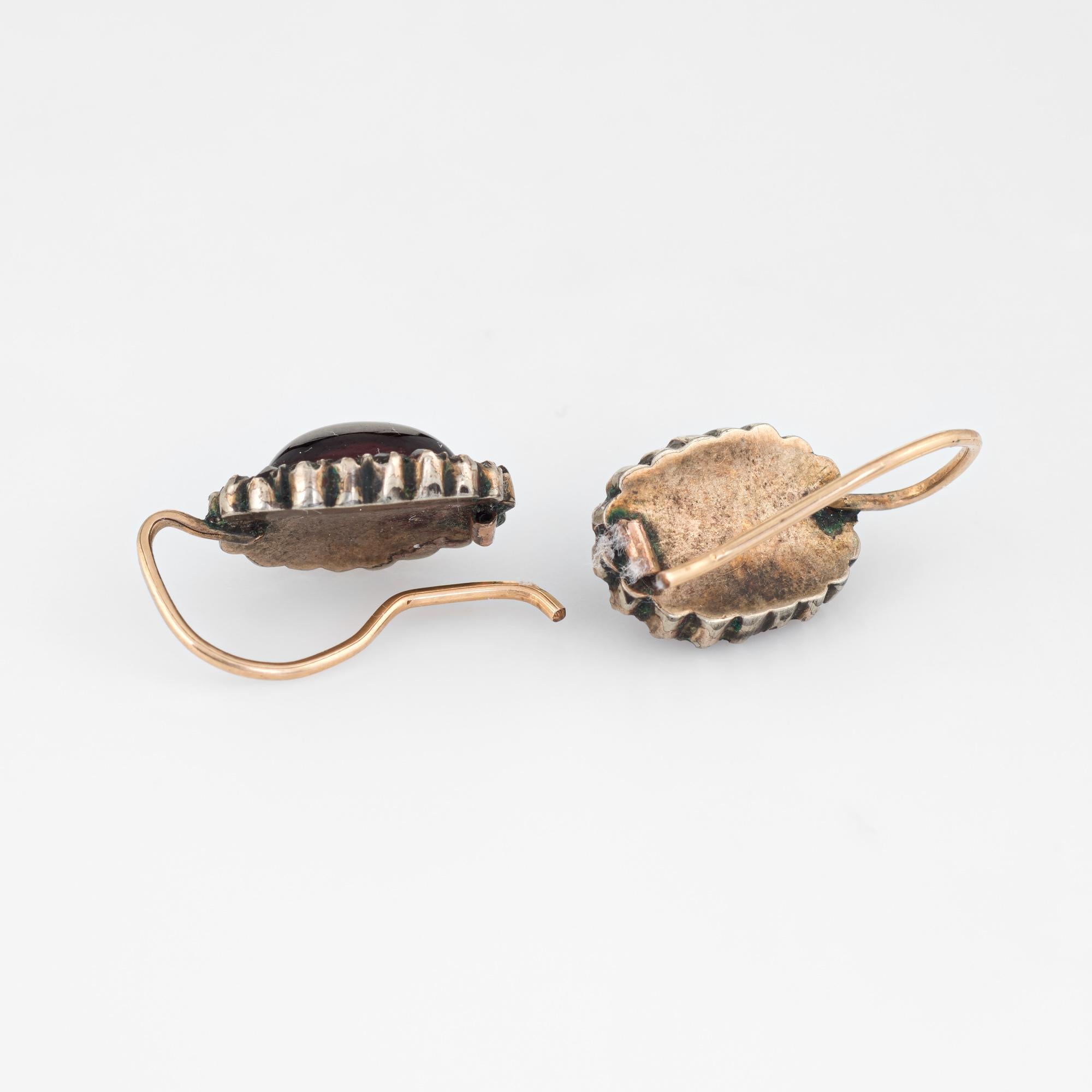 Elegant pair of antique Victorian garnet earrings (circa 1880s to 1900s) crafted in 10k rose gold. 

Cabochon cut garnet (center) measures 9mm x 7mm, accented with 36 (18 pear earring) bohemian cut garnets. The garnets are in good condition with