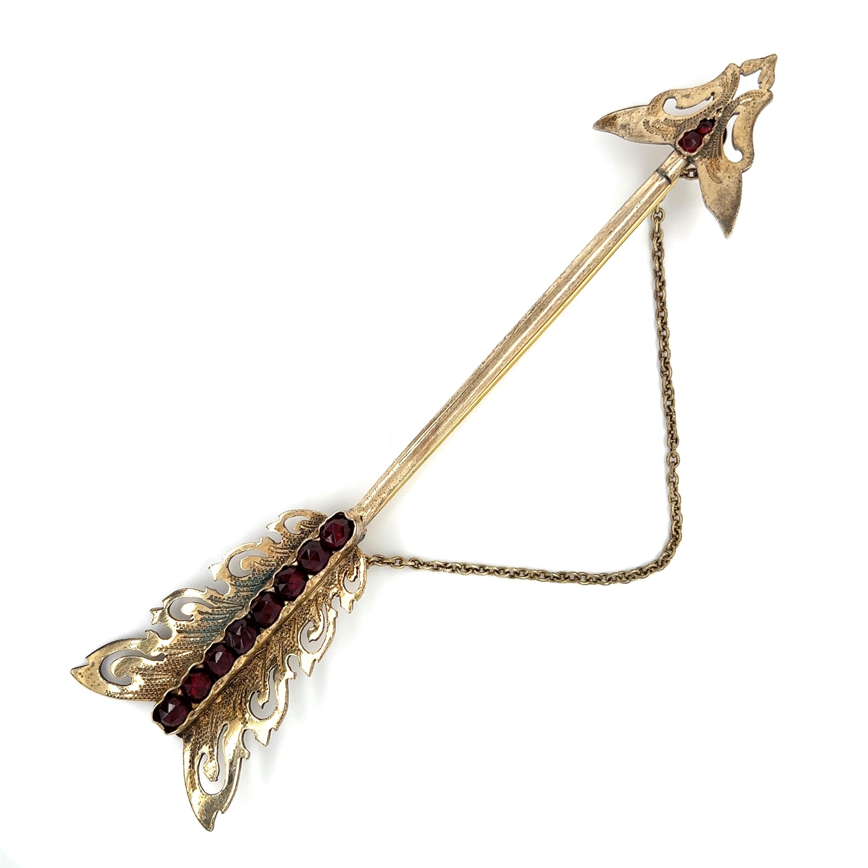 Simply Beautiful! Victorian Antique 12K Gold and Garnet Arrow Jabot Brooch Stick Pin. 12K Gold on Key and XRF. Pin closure is Brass. Centering Hand set Garnets. Approx. size: 5” Long. More Beautiful in real time...A sure to be admired piece you’ll
