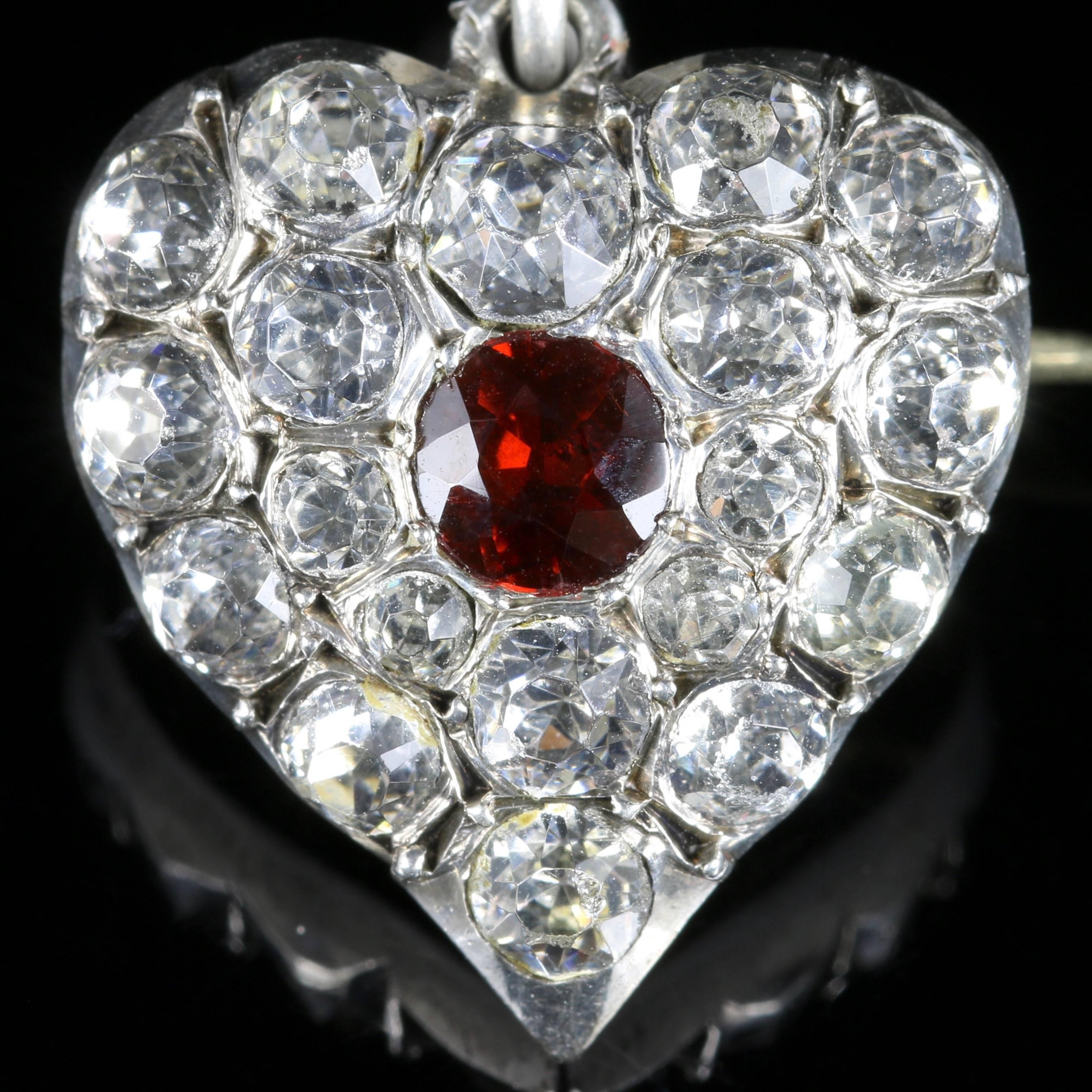 For more details please click continue reading down below...

This fabulous antique Victorian Silver heart shaped Brooch/Pendant is Circa 1900.

The wonderful brooch is adorned with sparkling white Paste Stones and a central rich red Garnet.

The