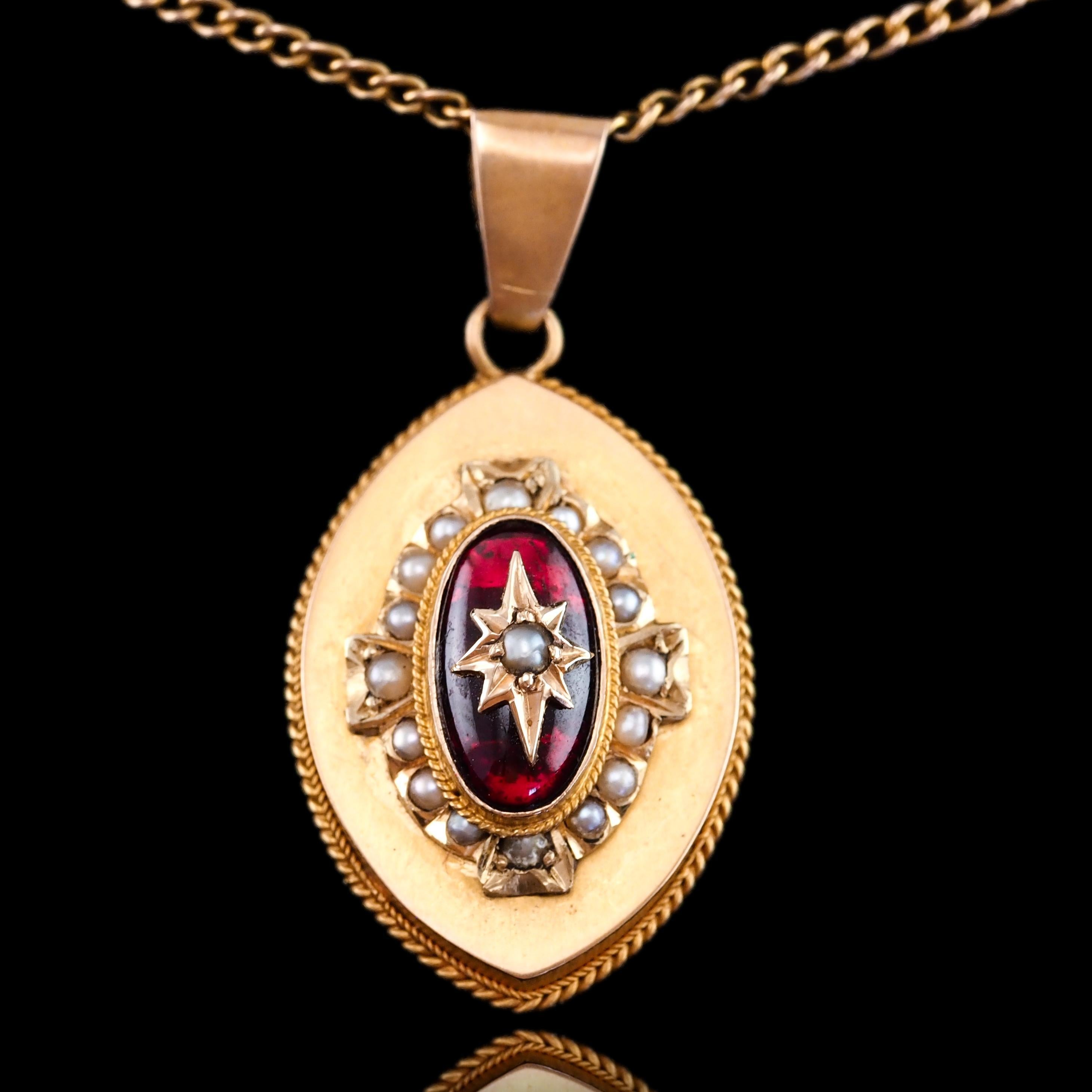 We are delighted to offer this stunning antique Victorian garnet and pearl pendant necklace made c.1880.

The pendant is made in 14ct antique gold and is set with a beautiful oval garnet cabochon in the centre with a cluster of seed pearls