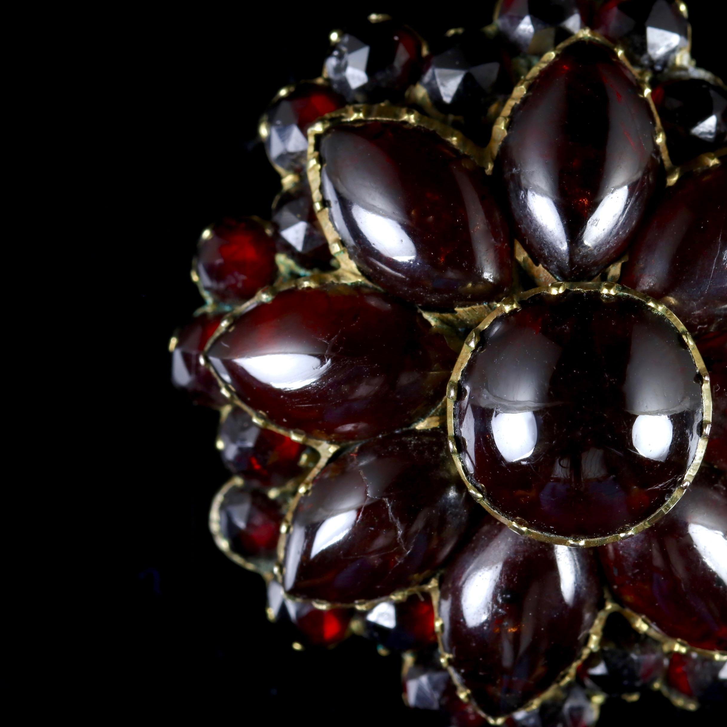 This fabulous Victorian Garnet pendant is Circa 1880.

The pendant boasts a large 4.5ct central Garnet, which is surrounded by marquise cut Garnets.

An outer halo of Garnets are facets and compliment the cabochon inner Garnet, making up a beautiful