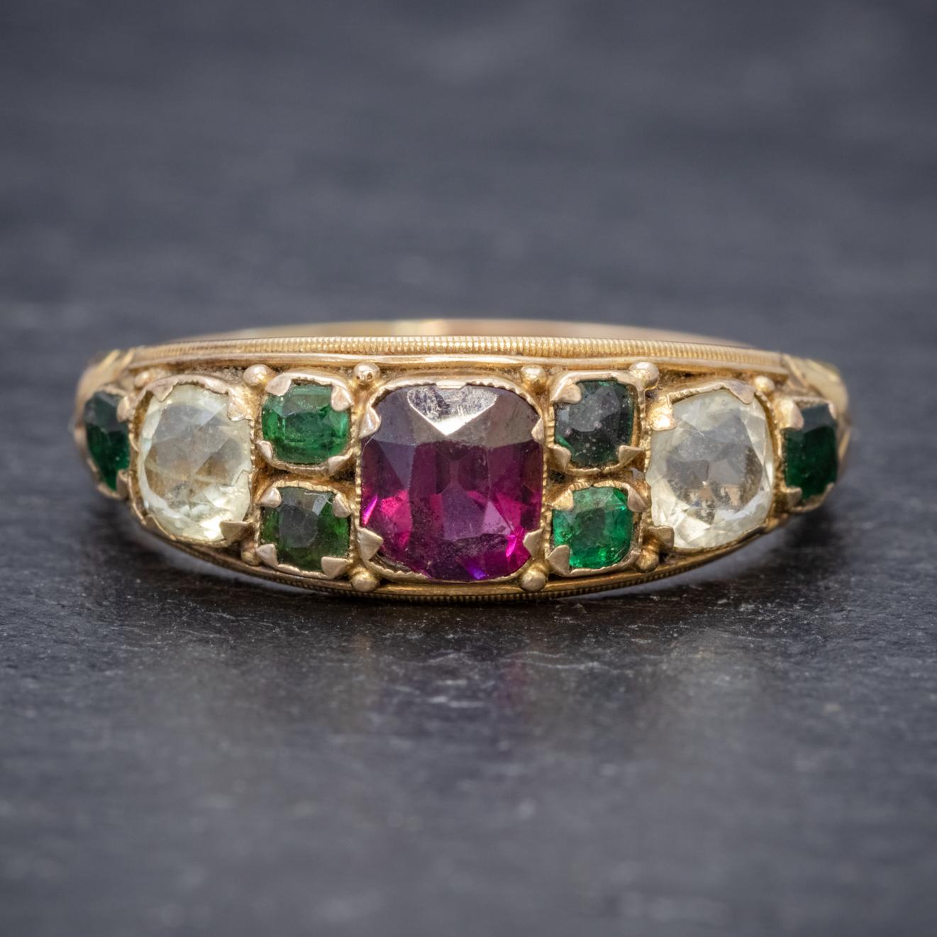 A beautiful antique Victorian ring boasting a splendid combination of gemstones including a 0.60ct Almandine Garnet in the centre, two clear 0.25ct Quartz stones and six 0.08ct green Garnets. 

The gallery is all 15ct Yellow Gold and displays lovely