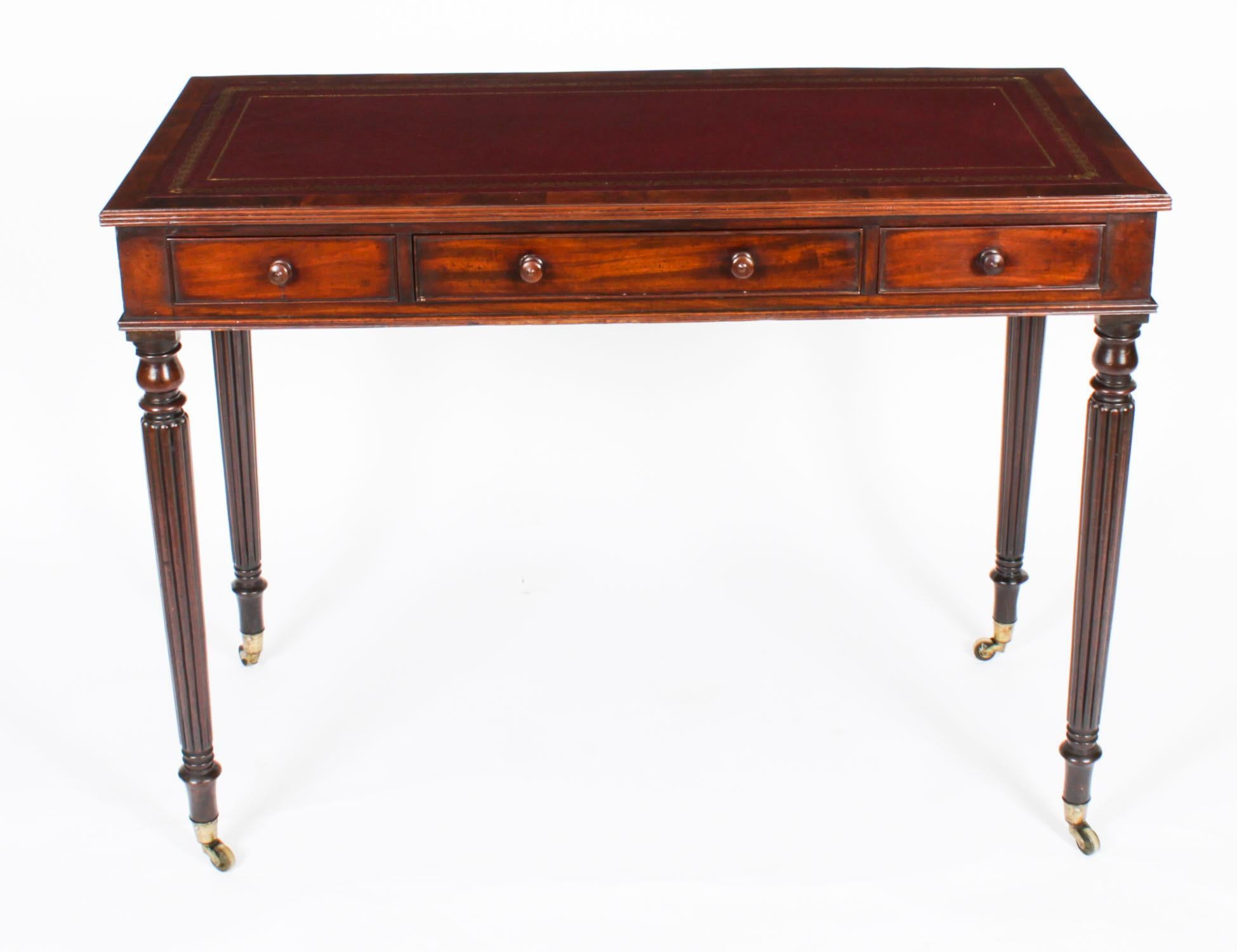 A superb antique Victorian flame mahogany writing table, by Gillow of Lancaster, circa 1860 in date.

The rectangular top features a moulded edge with a striking inset gold tooled burgundy inset leather writing surface  over three  drawers to the